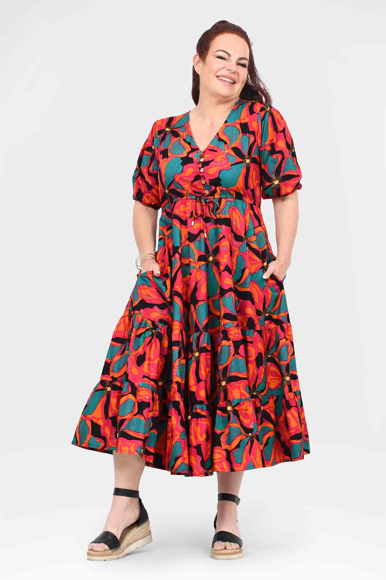 Tiered midi dress with vibrant coral and teal floral print, short puff sleeves and flared skirt