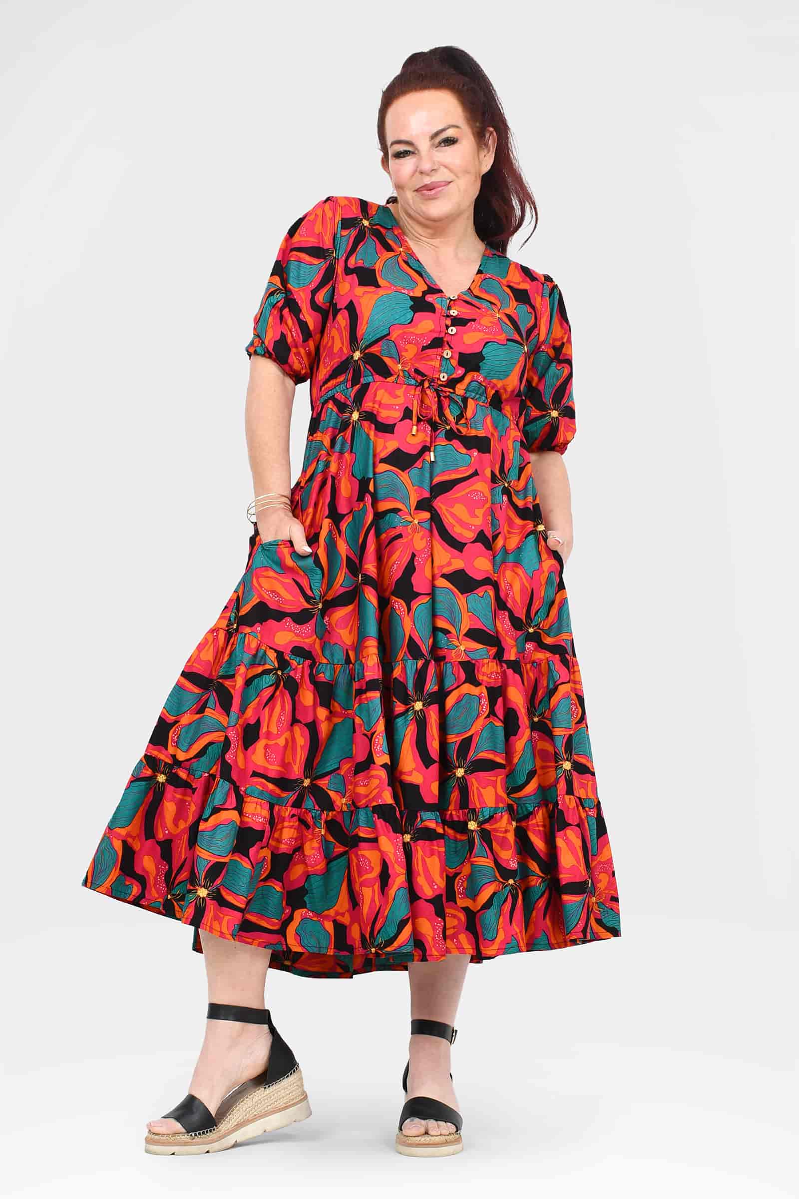 Tiered midi dress in vibrant coral and teal floral print, short puff sleeves, A-line skirt