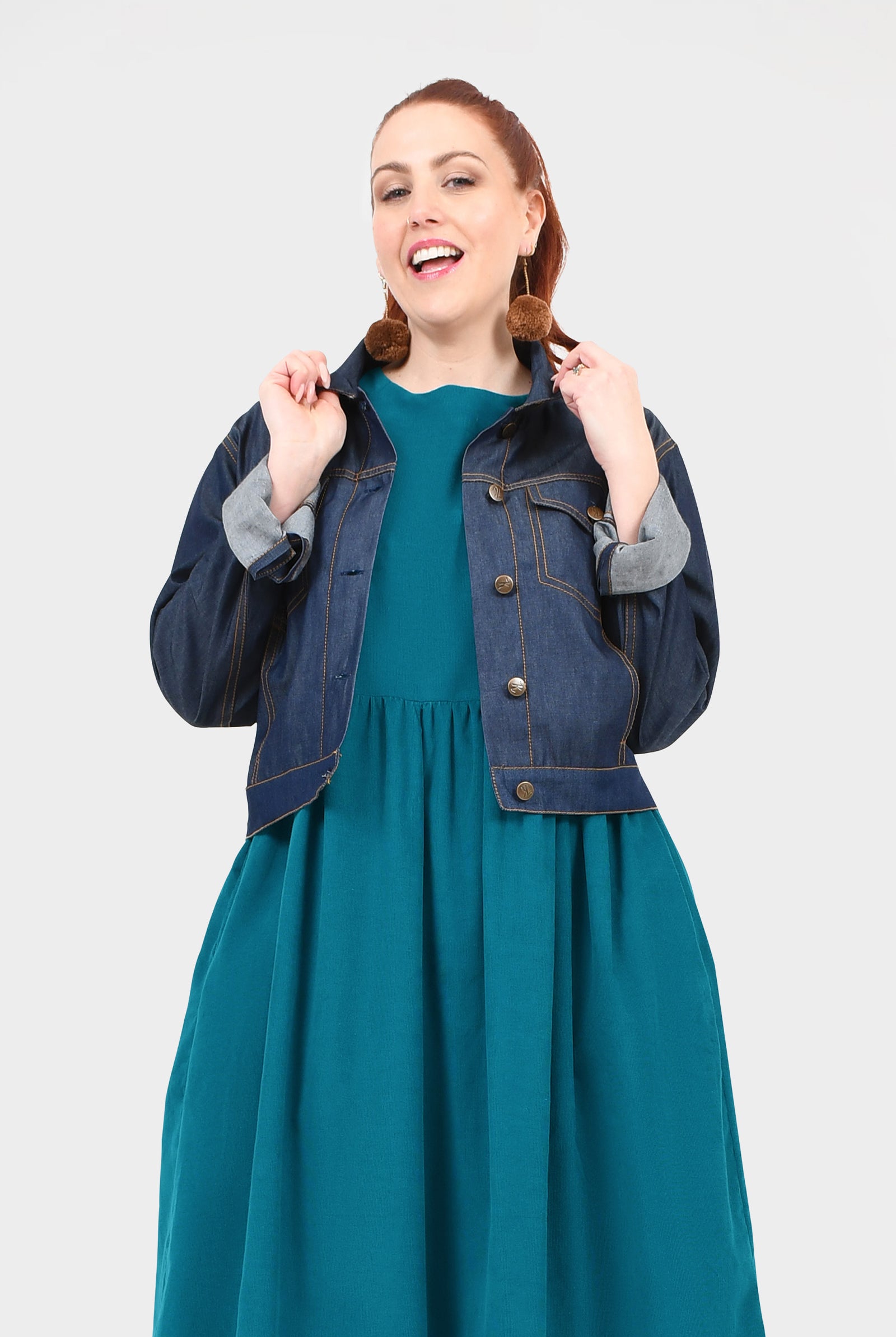 Dark blue denim jacket with buttoned front, chest pockets and buttoned cuffs