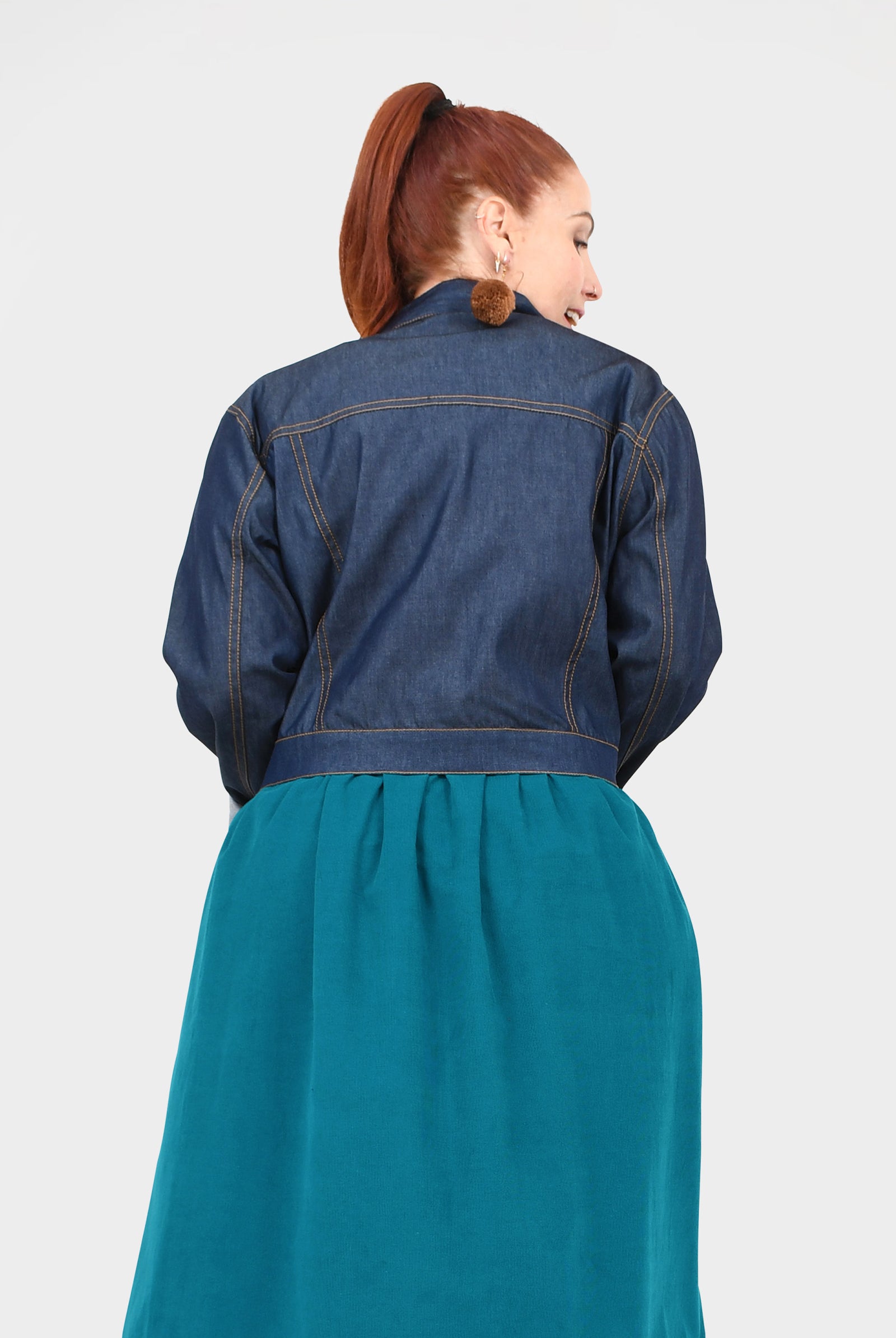 Dark blue denim jacket, back view, yoke design and buttoned collar