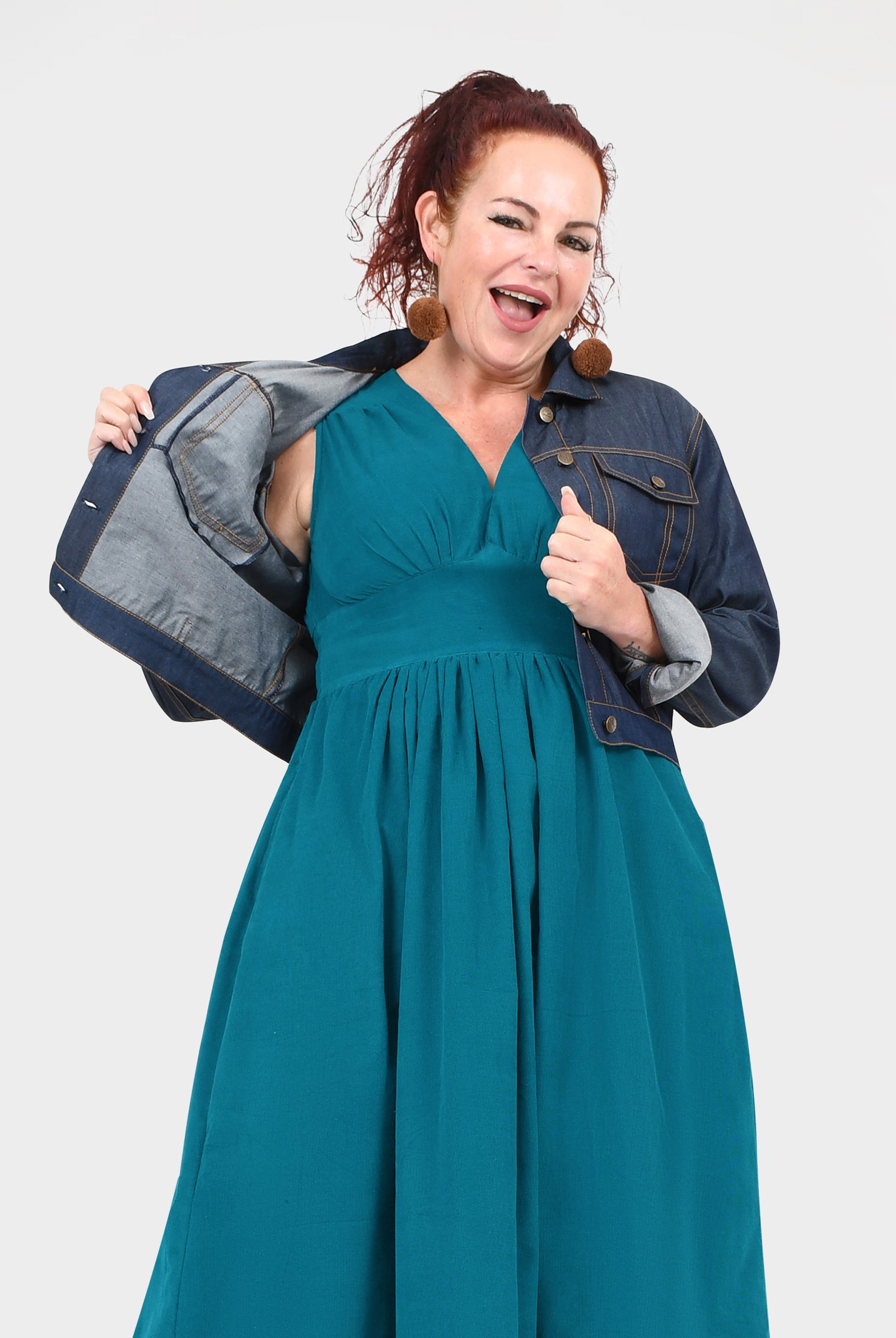 Dark blue denim jacket with long sleeves, flap pockets, and snap buttons
