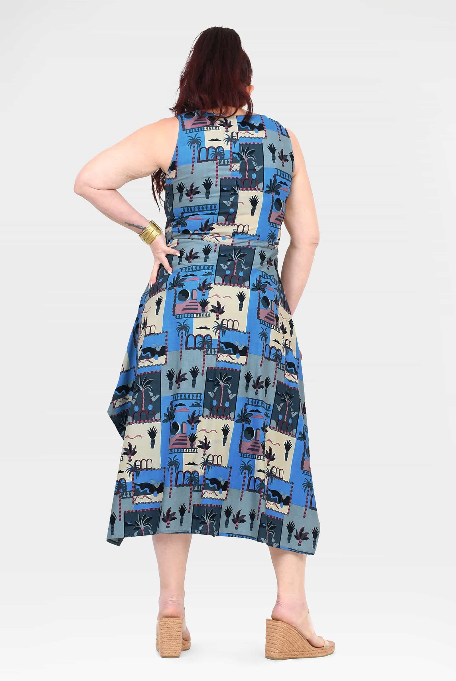 Capri dress sleeveless back view, blue-and-cream cartoon patchwork print, midi flare