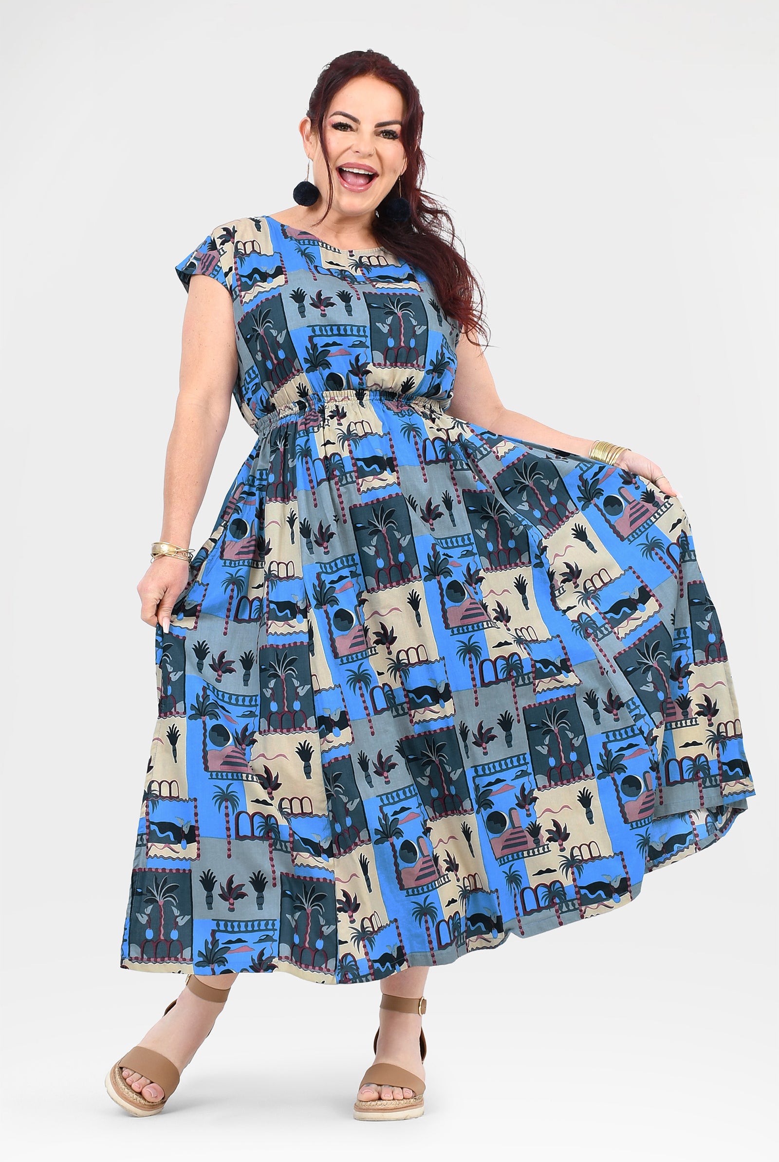 Blue and cream long dress with cap sleeves, gathered skirt, and illustrated skyline print