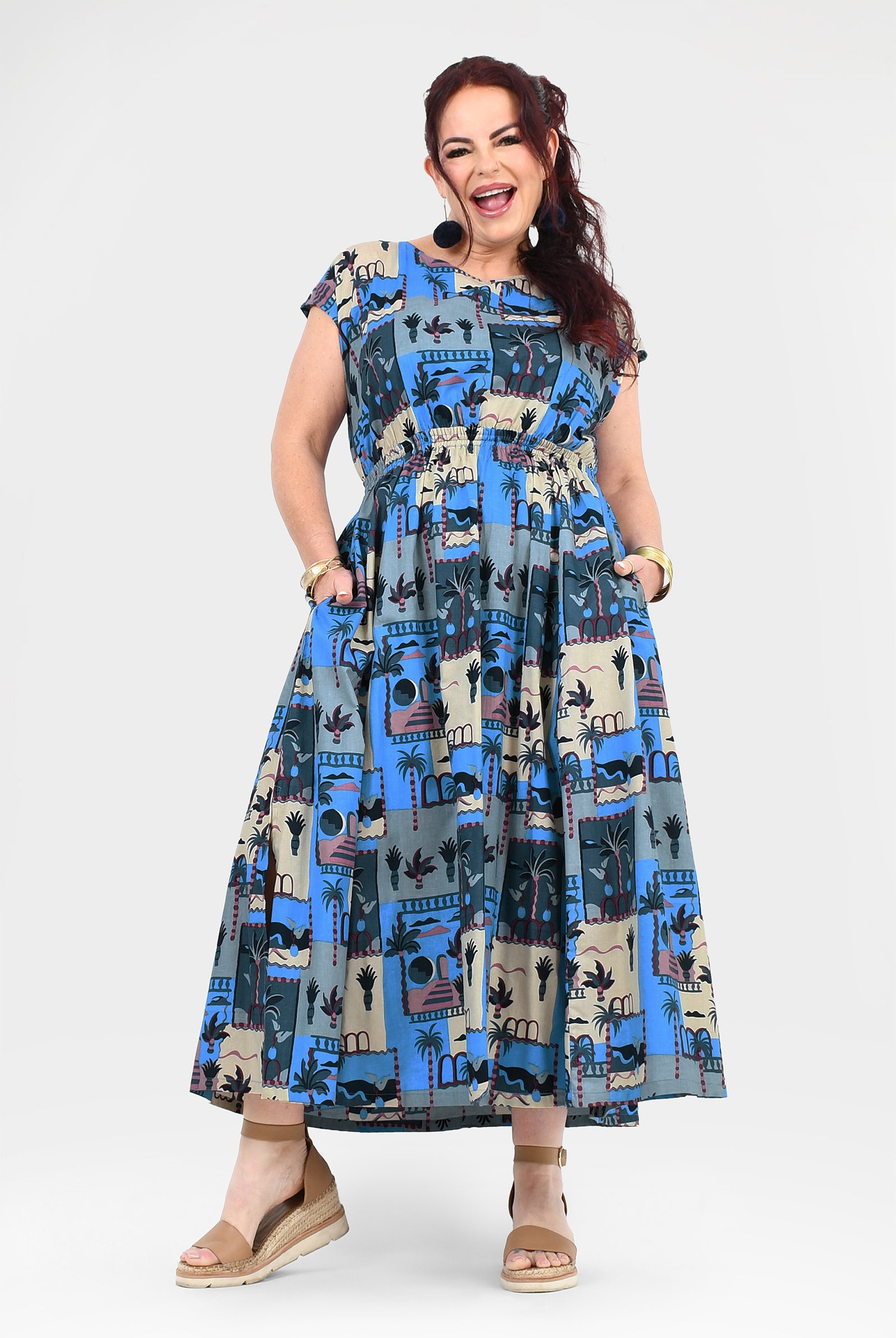 Blue-and-cream long dress with cap sleeves, gathered waist, and colorful illustrated print