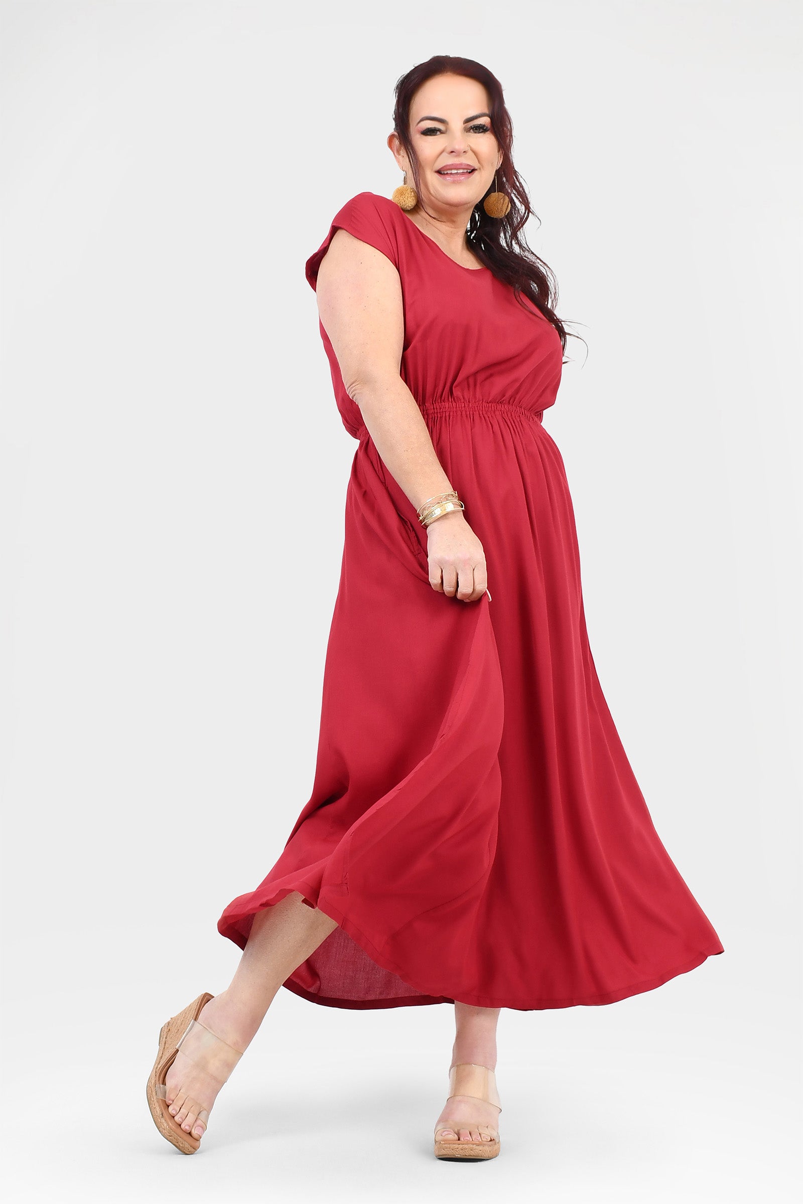 Dark red long dress with short sleeves, gathered waist and flowing skirt