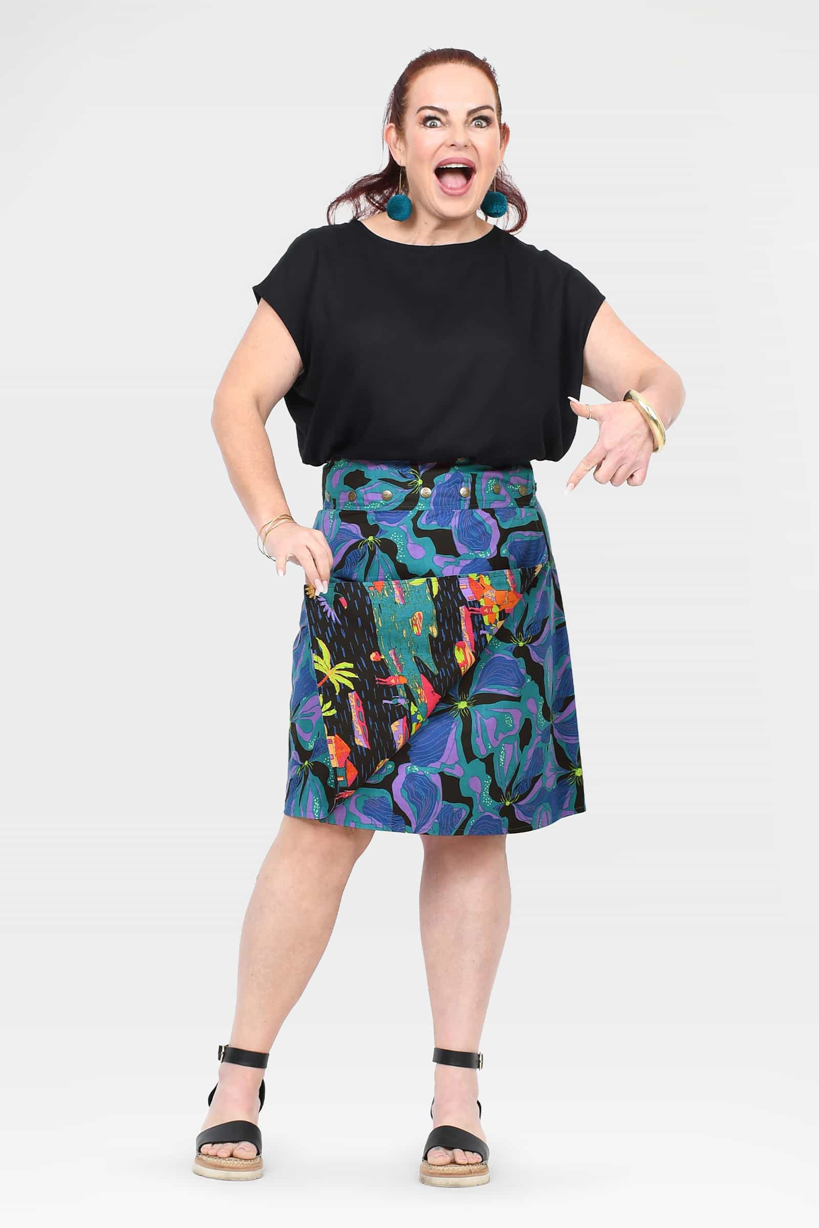 Front view of tropical print skirt on dark base with flared A-line hem