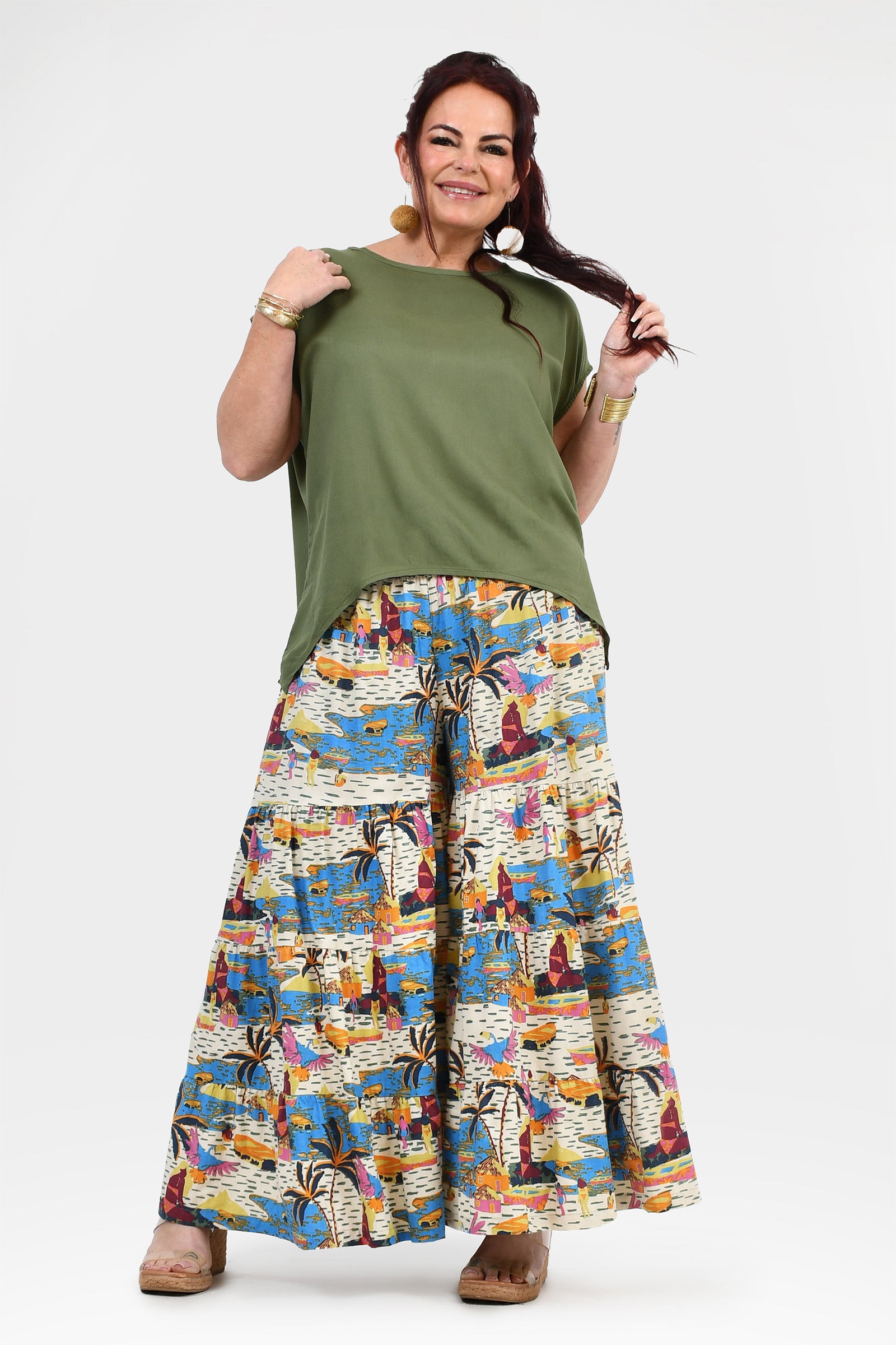 White-based wide-leg pants with blue and orange jungle print, full gathered silhouette