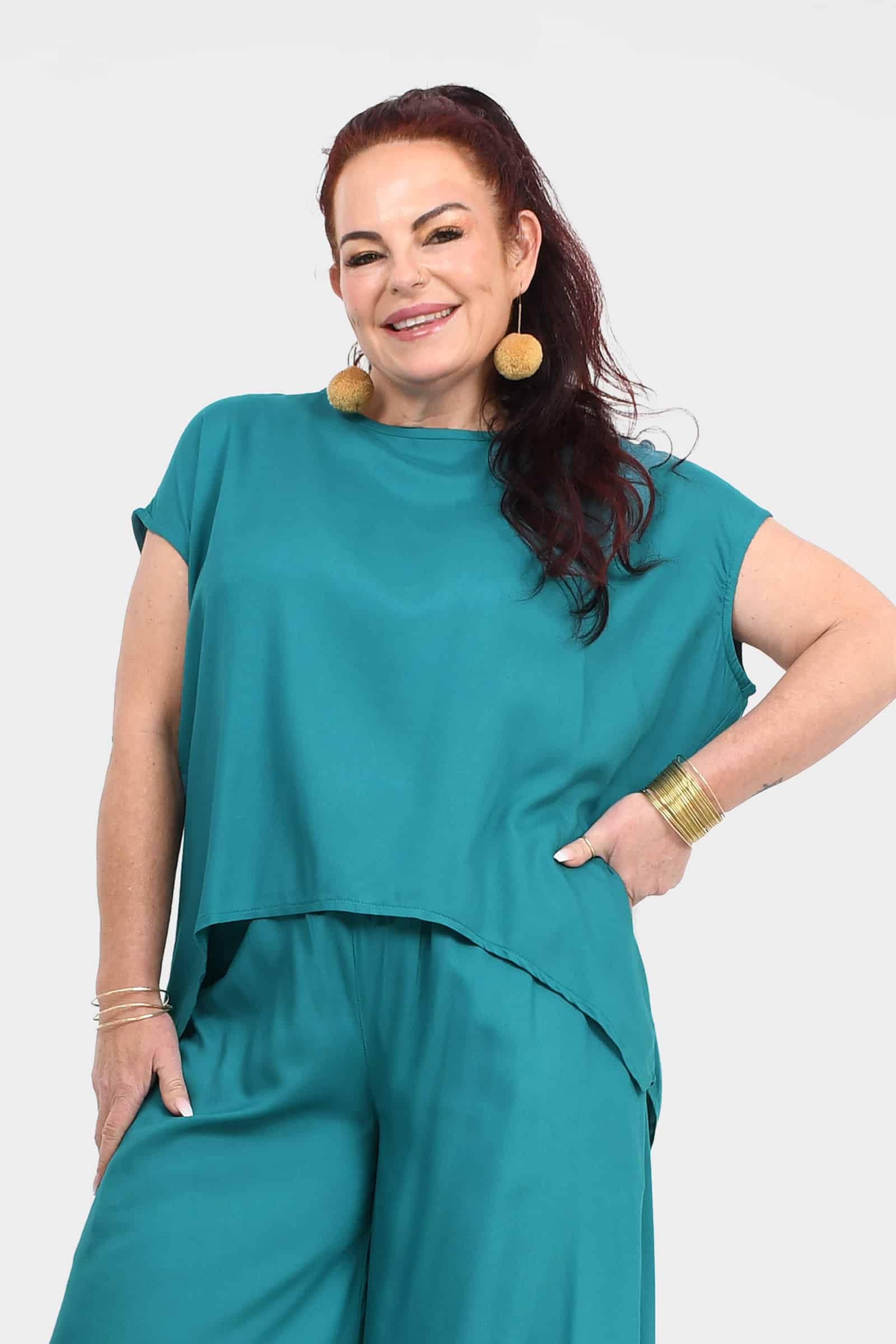 Teal short-sleeve crewneck top with layered-look hem detail, front view