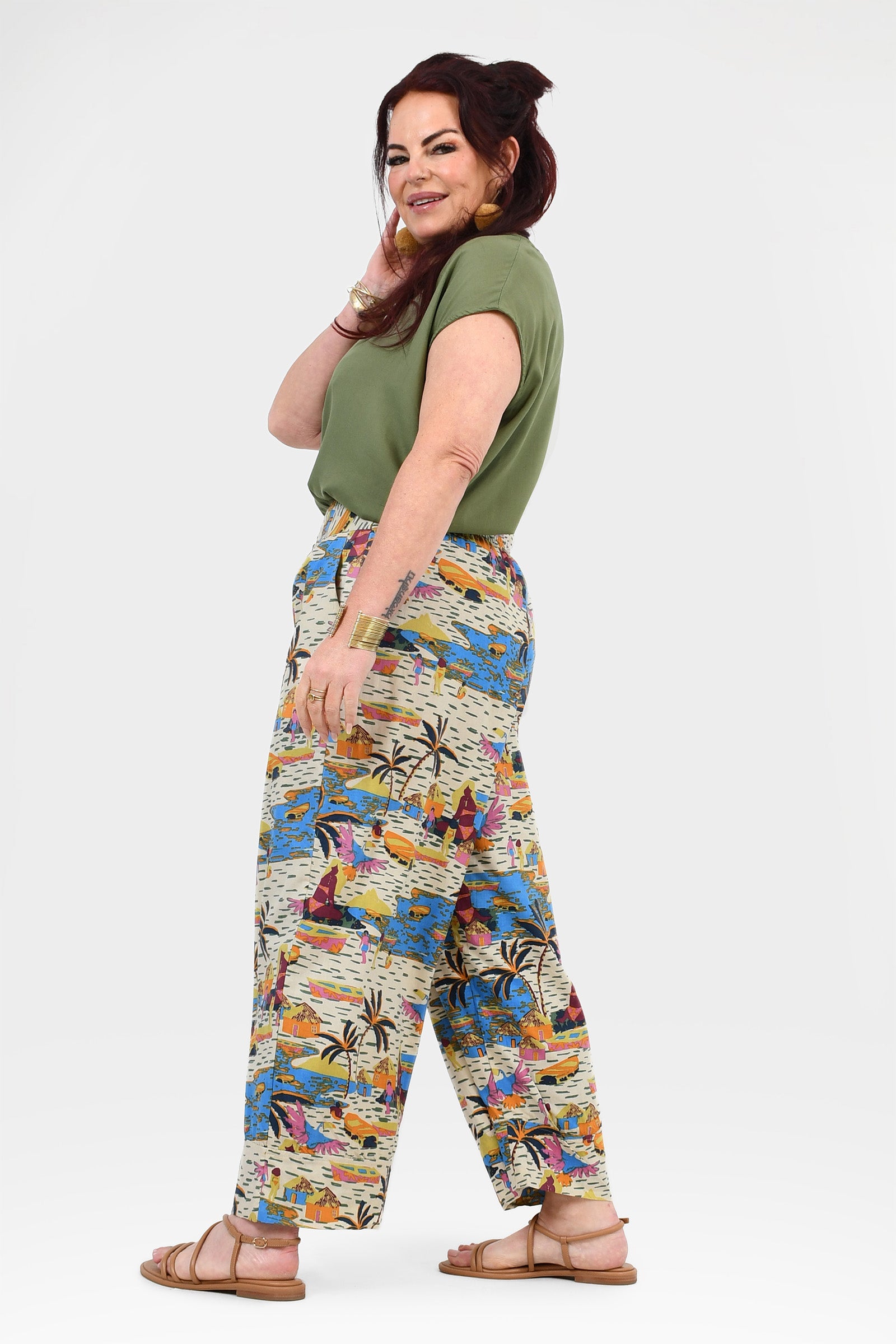 Side view of colorful printed wide-leg pants on an off-white base