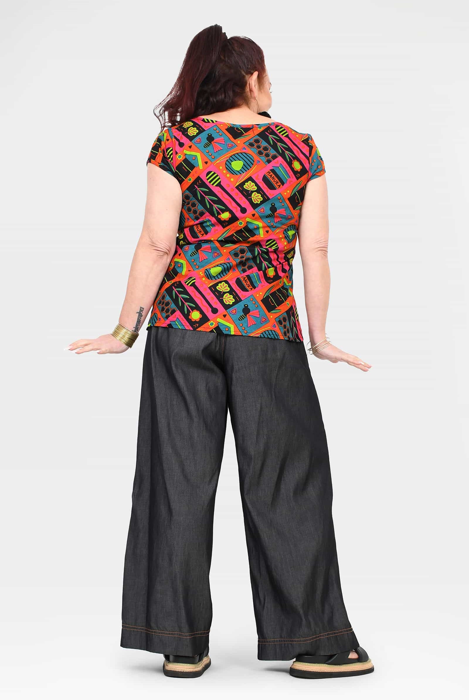 Black denim wide-leg long pants, back view, contrast stitching and wide cuffs