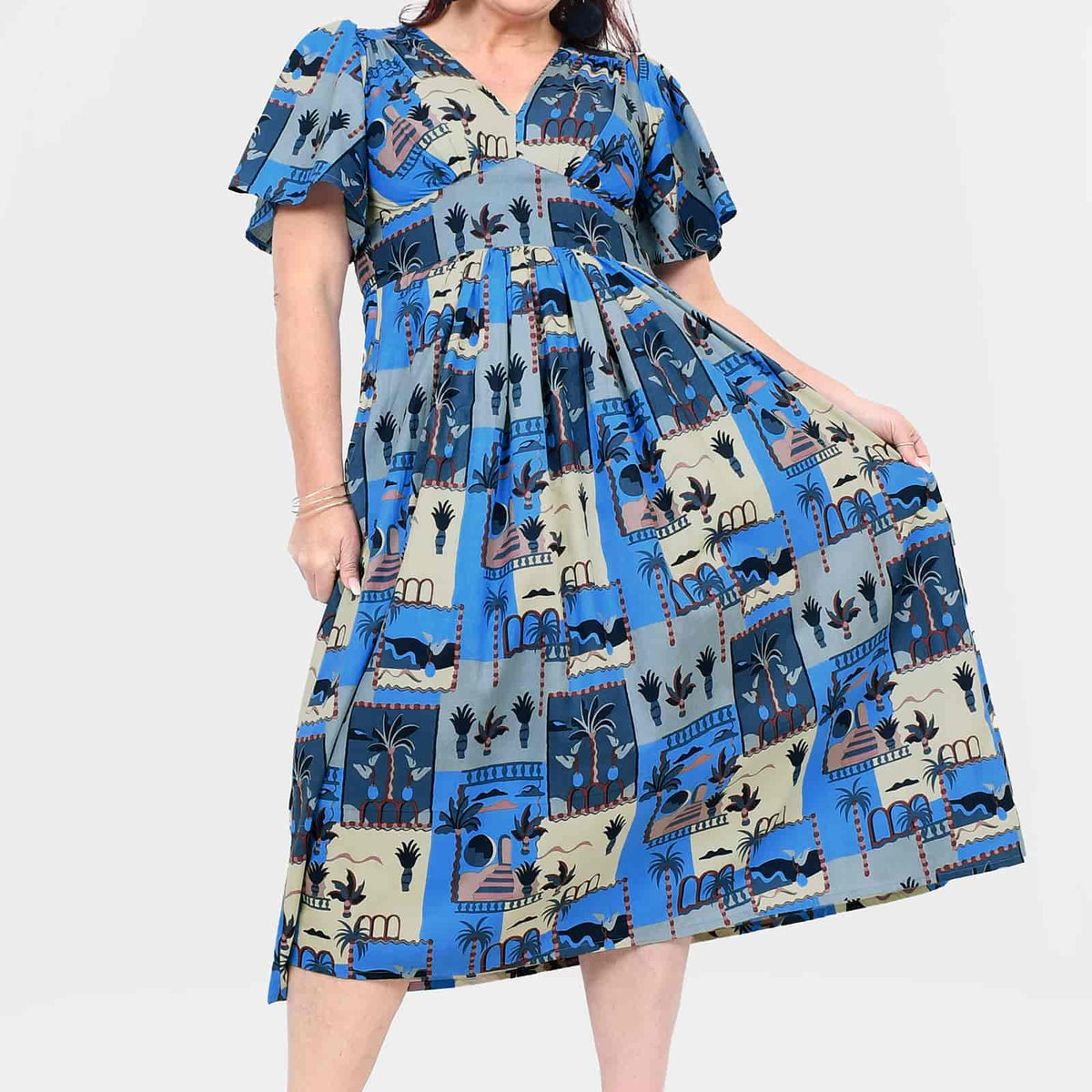 Blue midi dress with short sleeves, cinched waist, and cityscape print