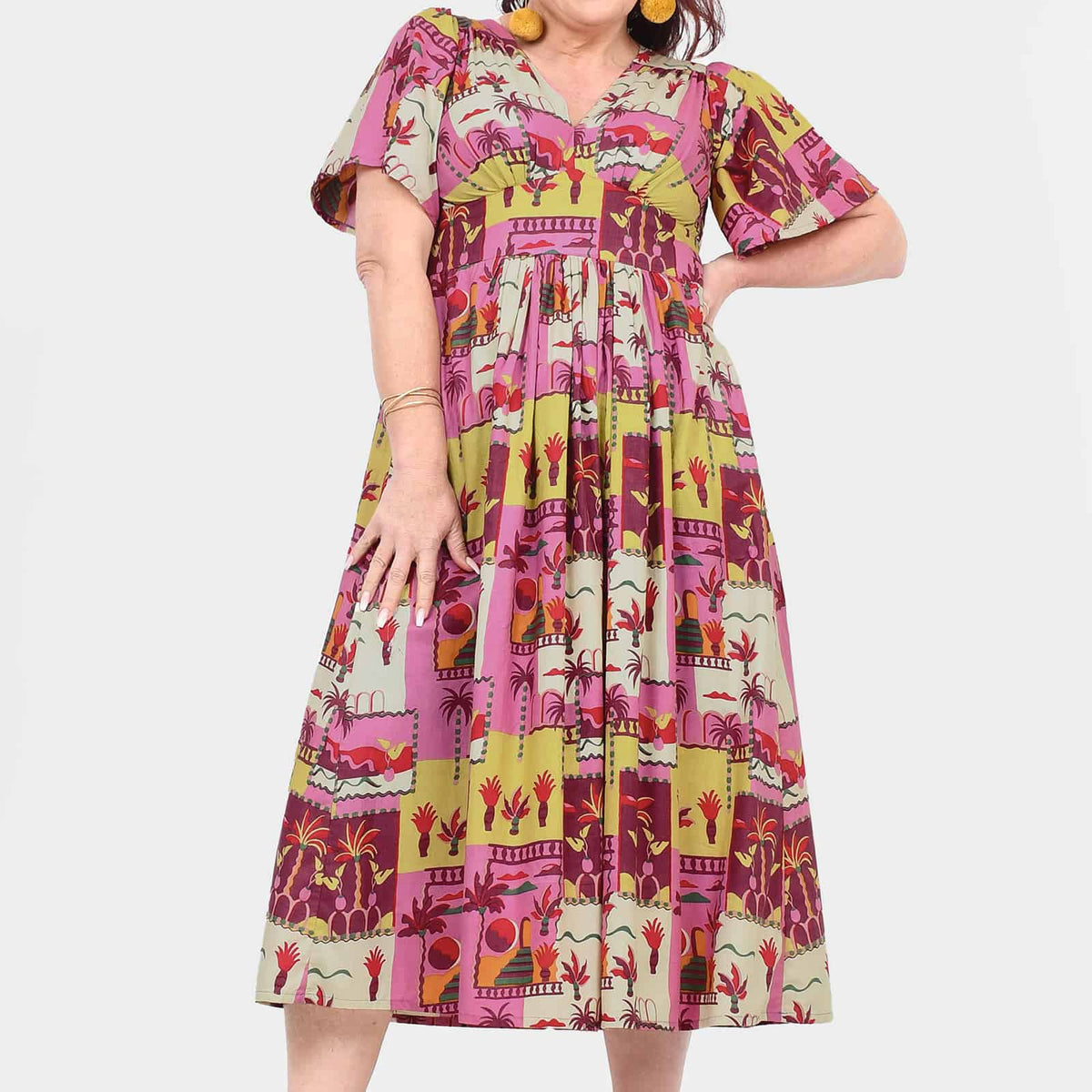 Pink midi dress with V-neck, short sleeves, and colorful patchwork print