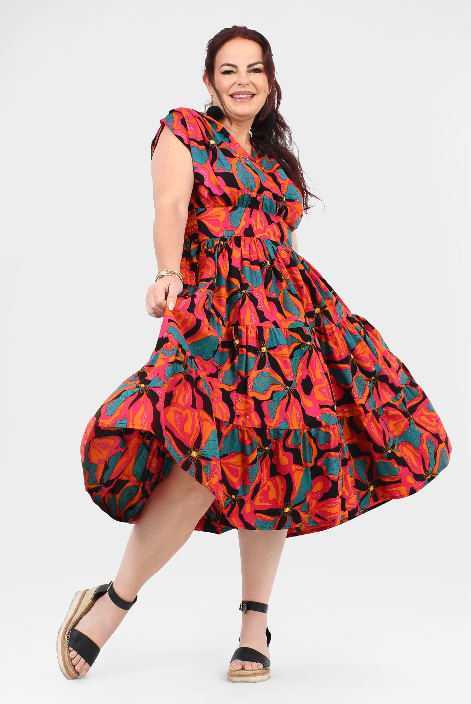 Multicolor floral midi dress with ruffled tiered skirt, short sleeves, and tied waist
