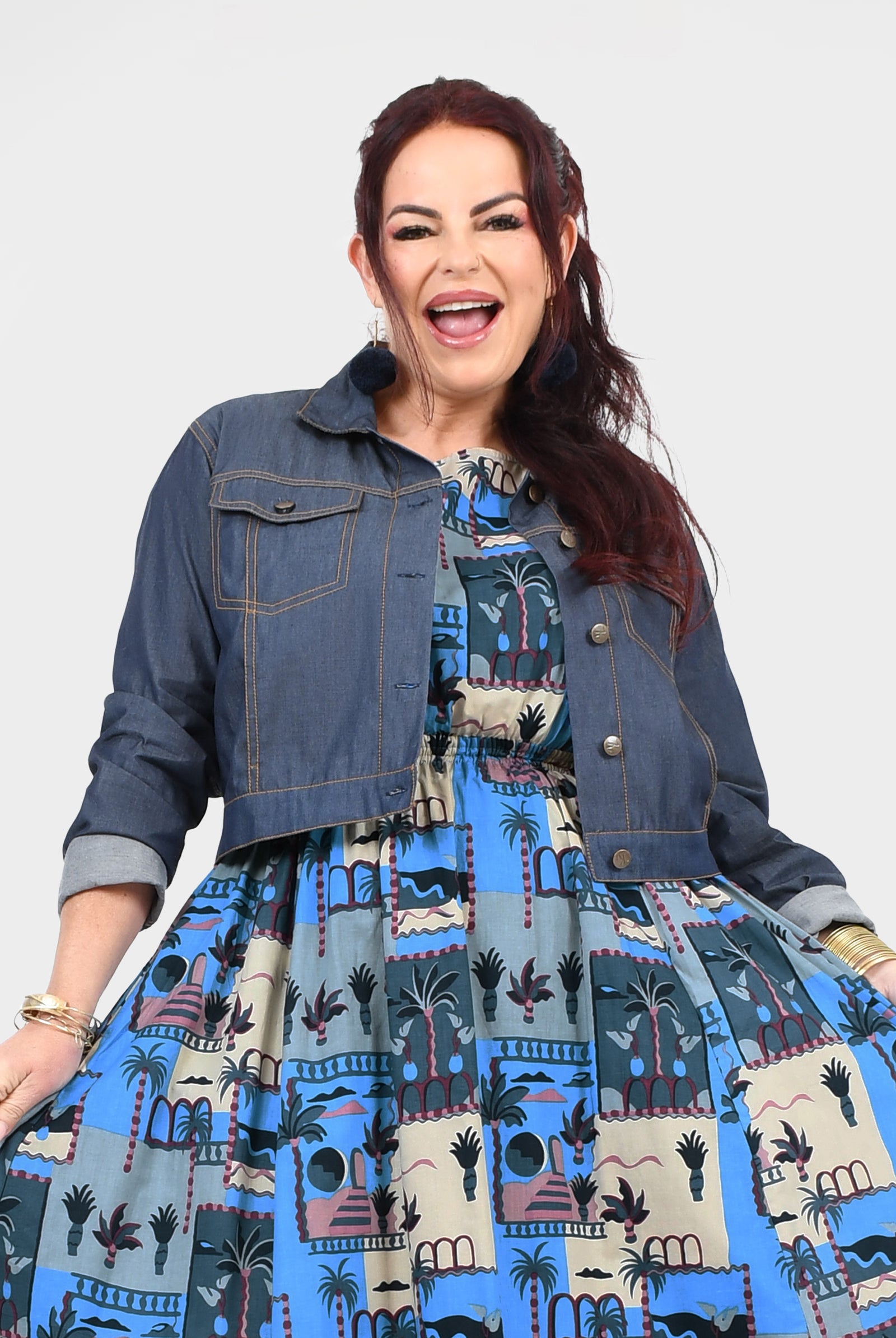 Blue denim jacket with button front, chest flap pockets, long sleeves and stand collar
