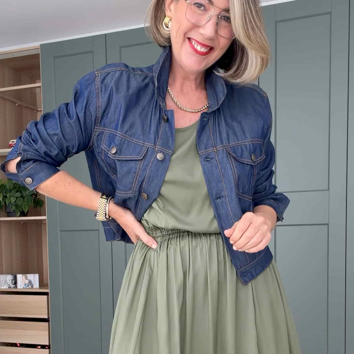 Blue denim jacket with button front, two chest pockets, and long sleeves