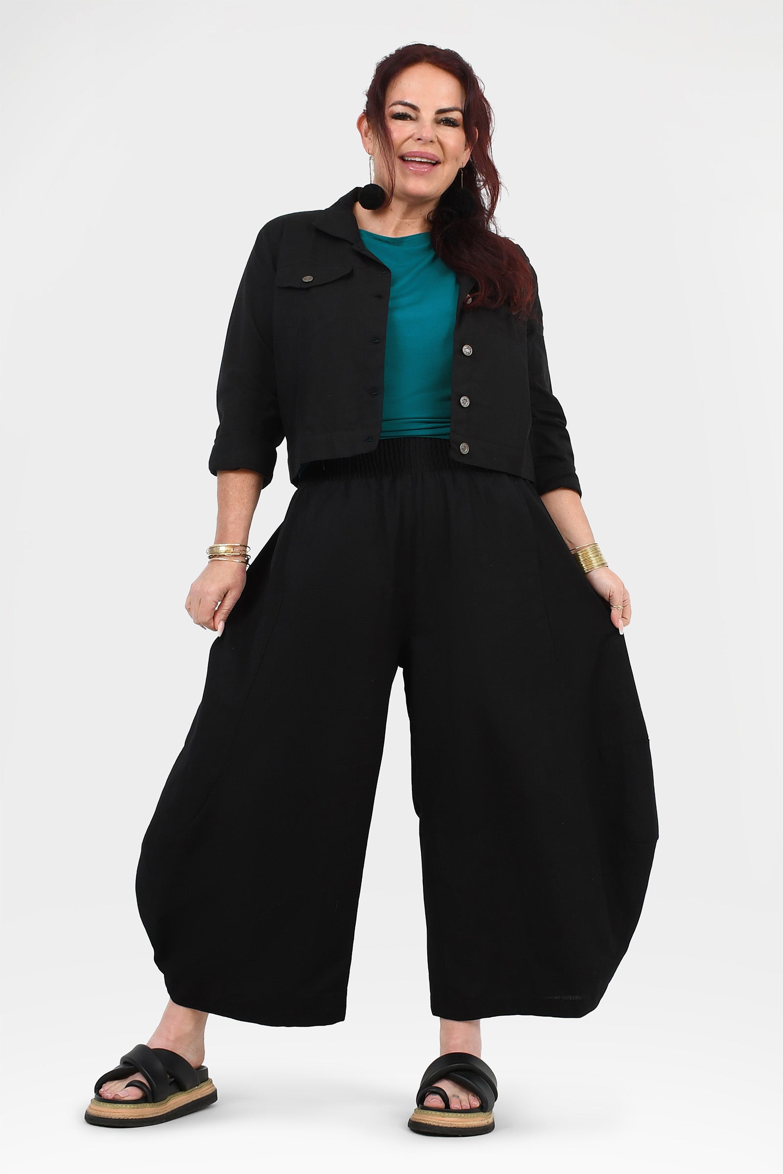 Black loose wide-leg pants with elastic waistband and relaxed drape, full front view
