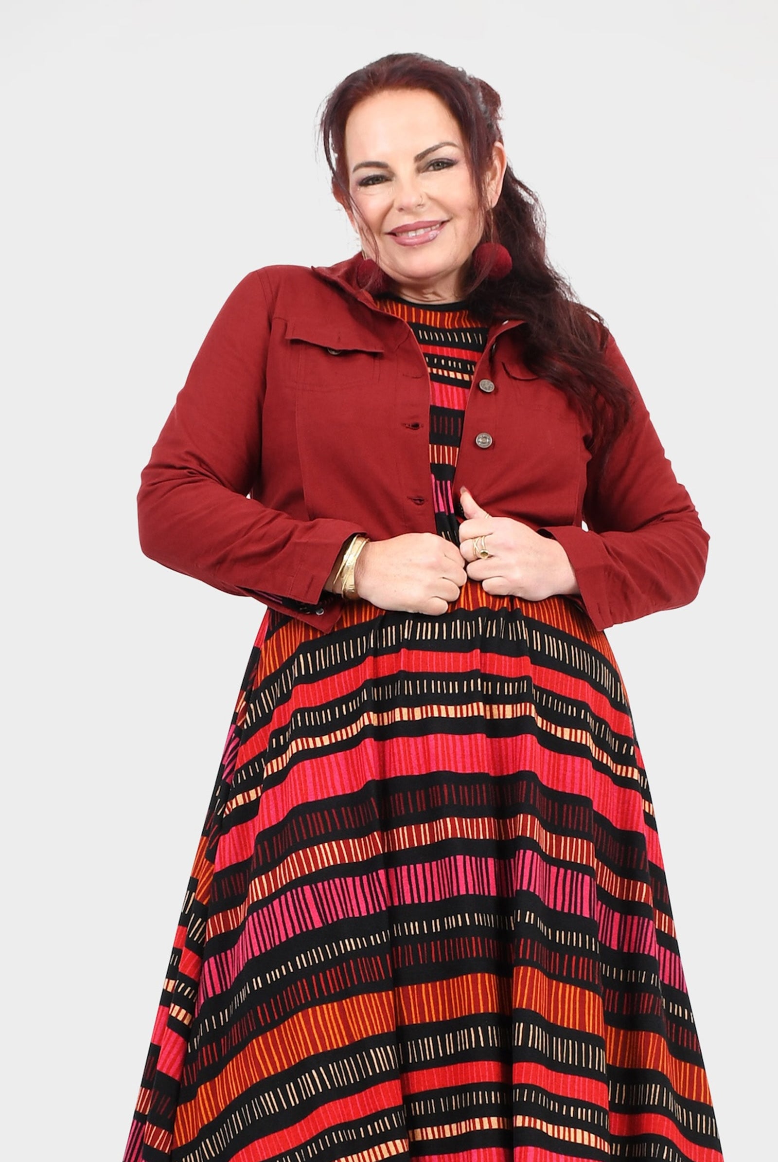 Dark red jacket with button placket, pointed collar, and chest pockets