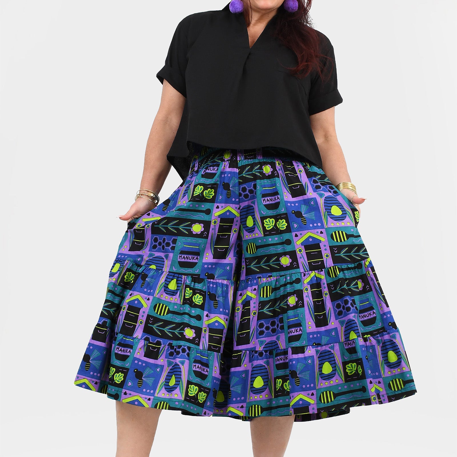 3/4 pants with black waistband and teal/purple novelty print, gathered tiers