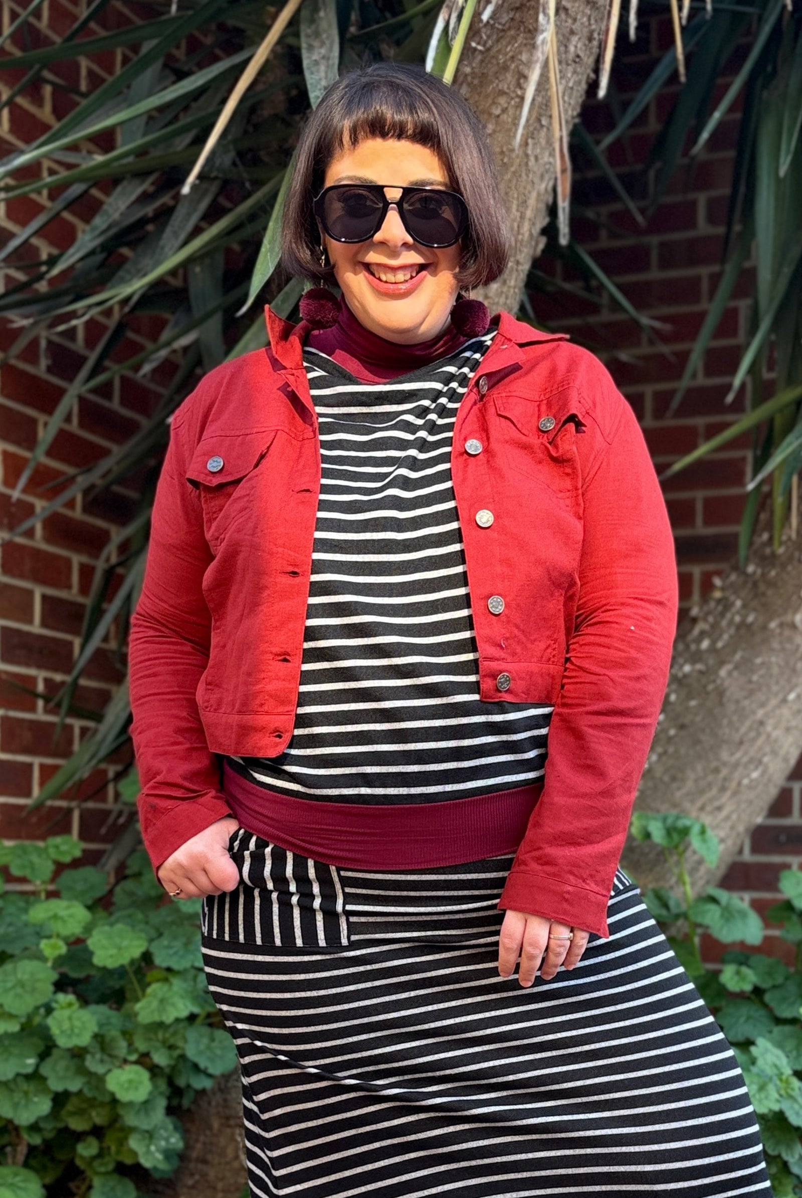 Dark red button-front jacket with chest pockets and pointed collar