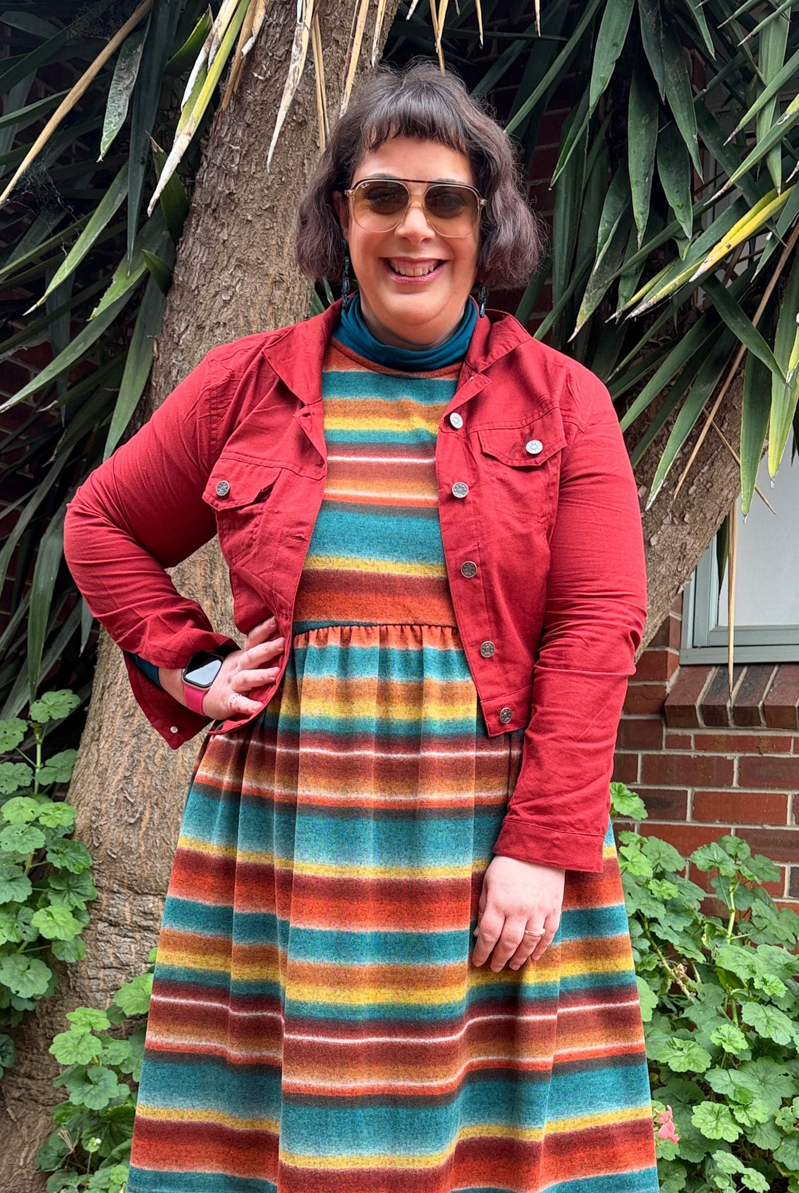 Dark red button-front jacket with flap pockets and button cuffs