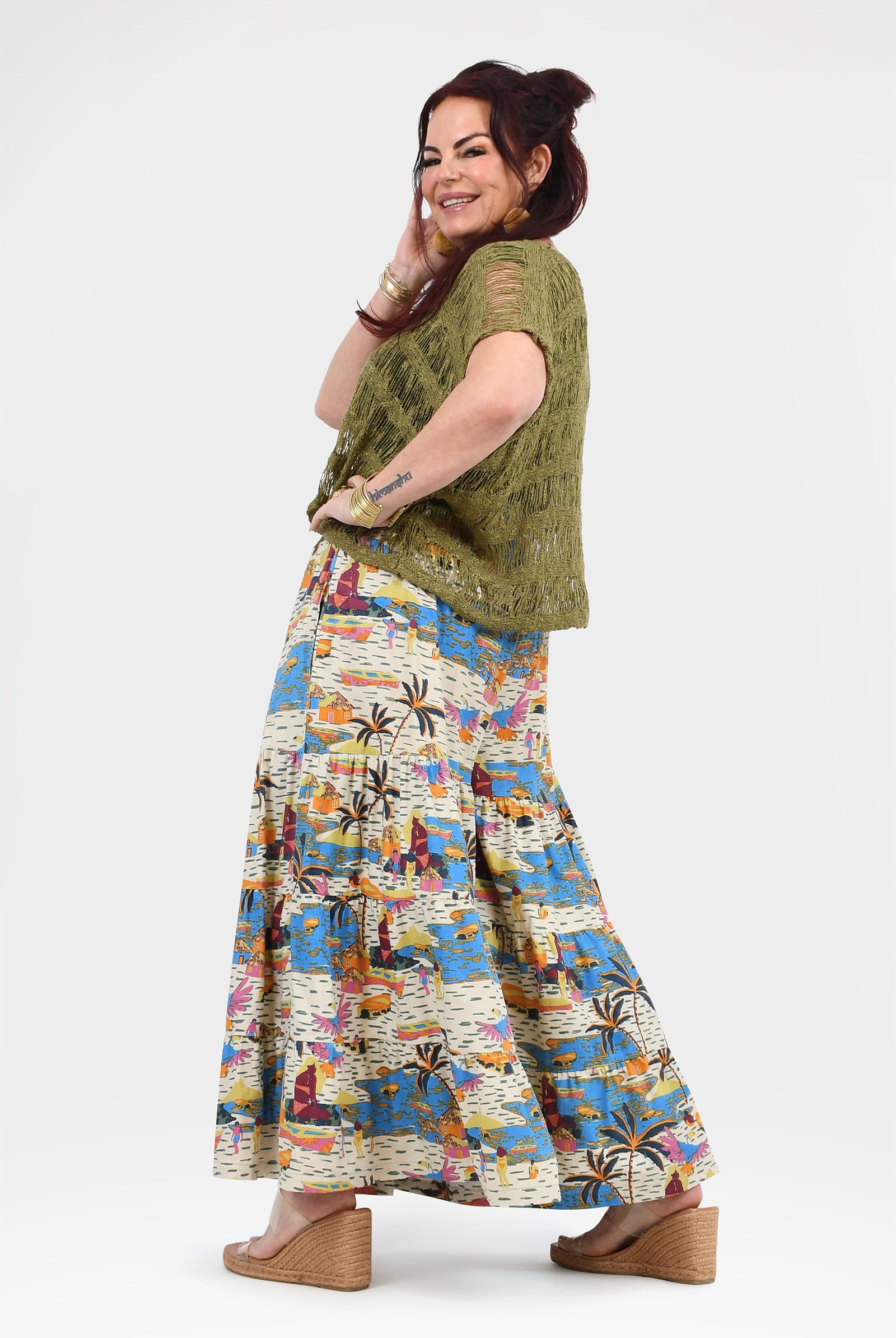 Wide-leg pants with white background and blue-orange tropical print, loose gathered drape
