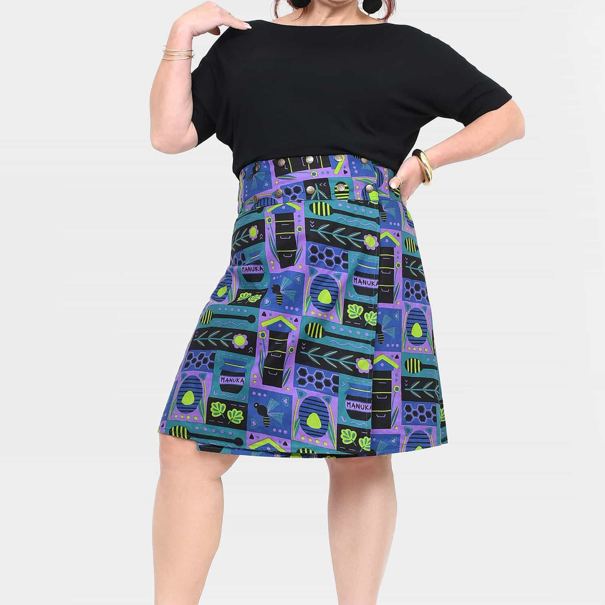 Reversible button skirt, black top with colorful pattern panels, knee length