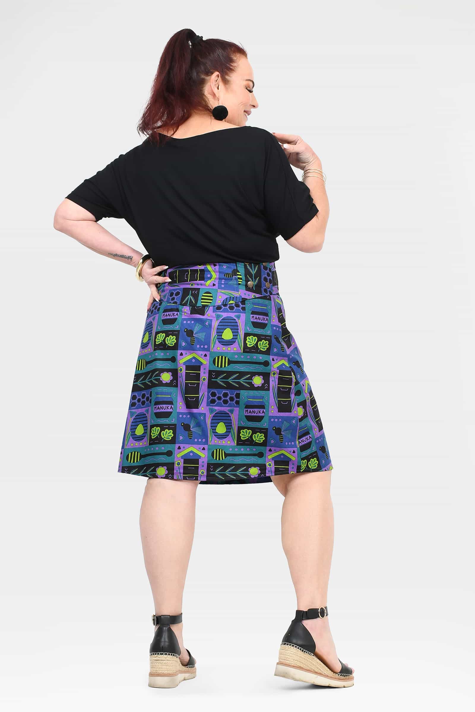 Reversible button skirt, black back and teal-purple pattern with inset panels
