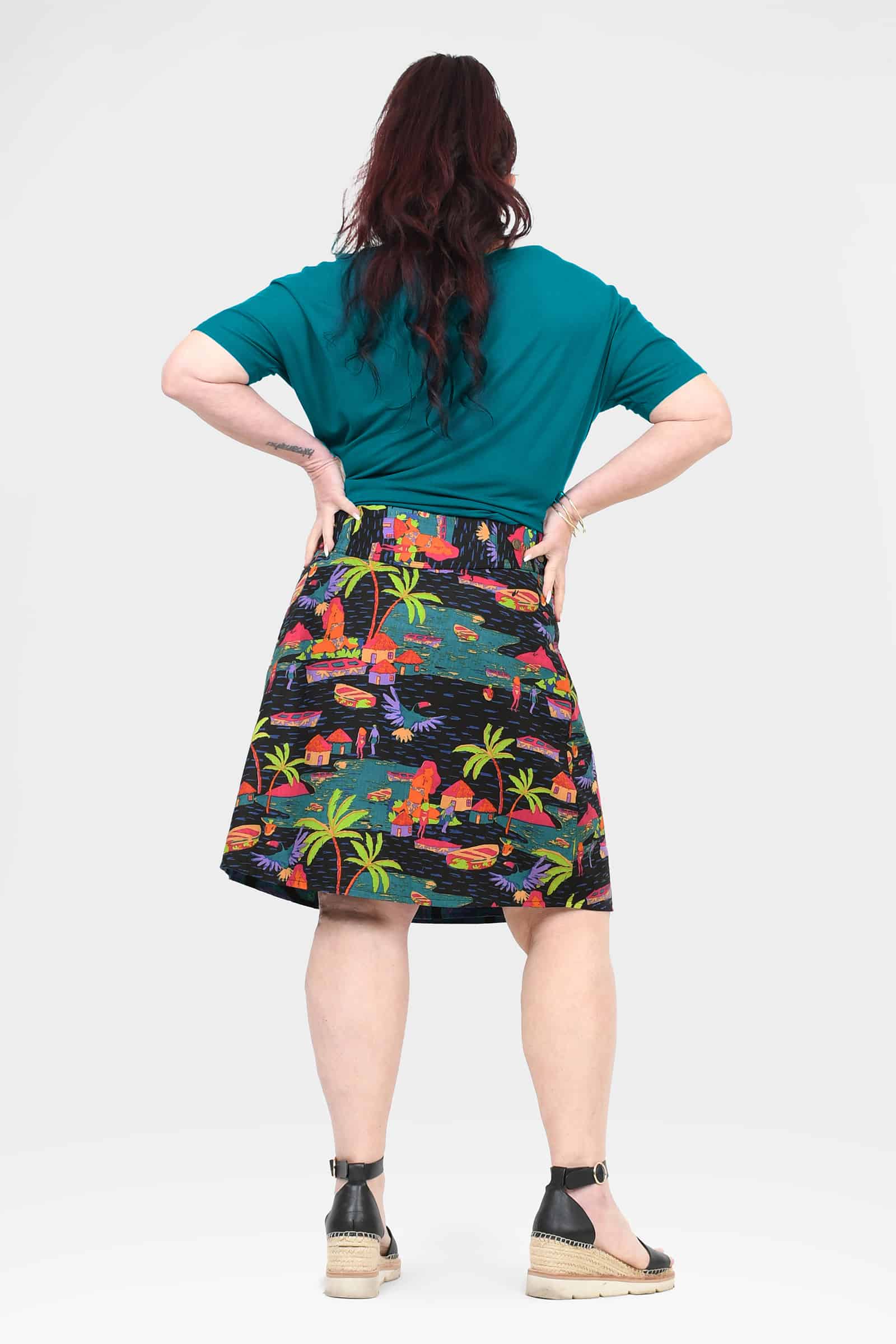 Long reversible button skirt, back view with multicolor tropical print