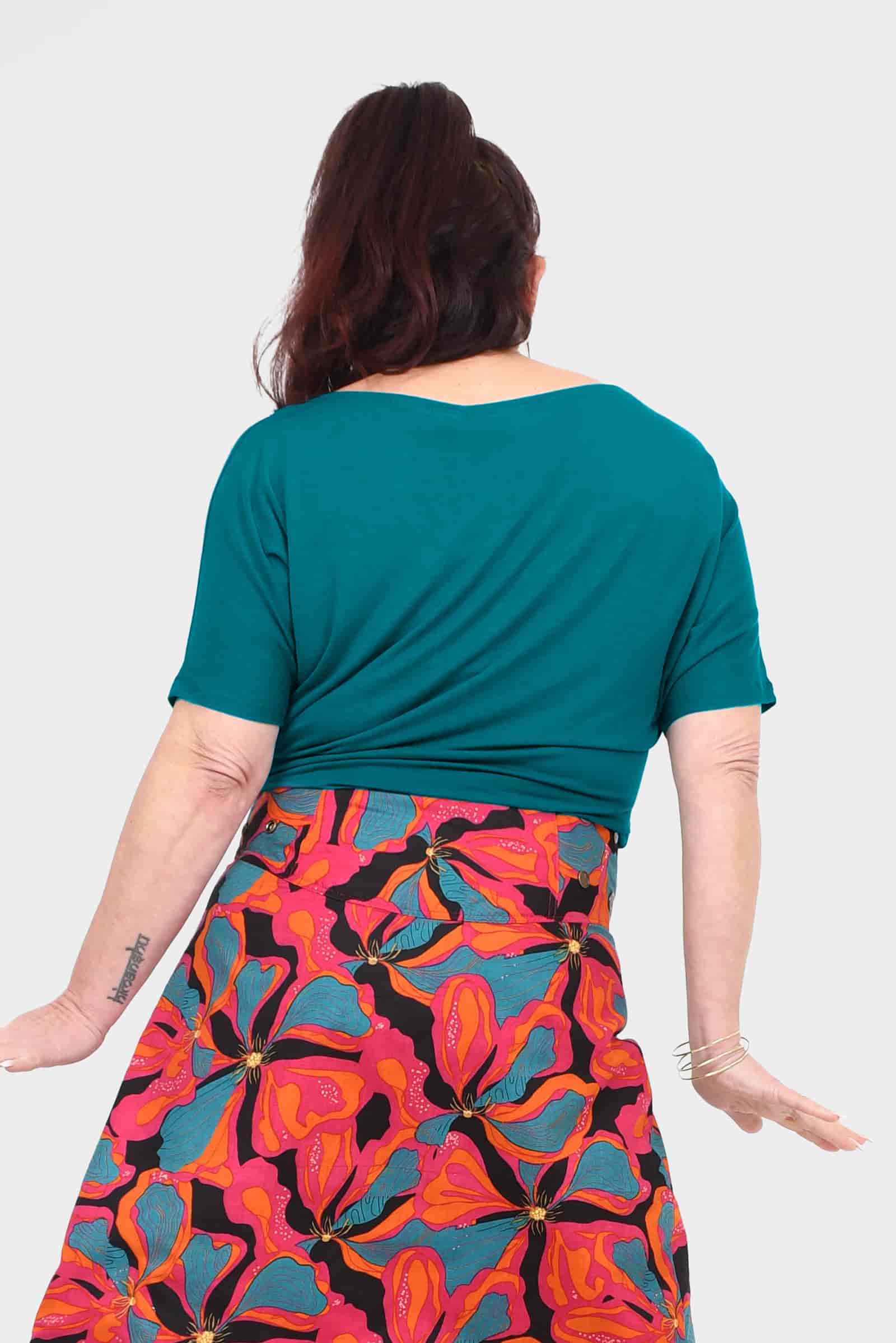 Back view of dark teal short-sleeve crew-neck top with relaxed drape