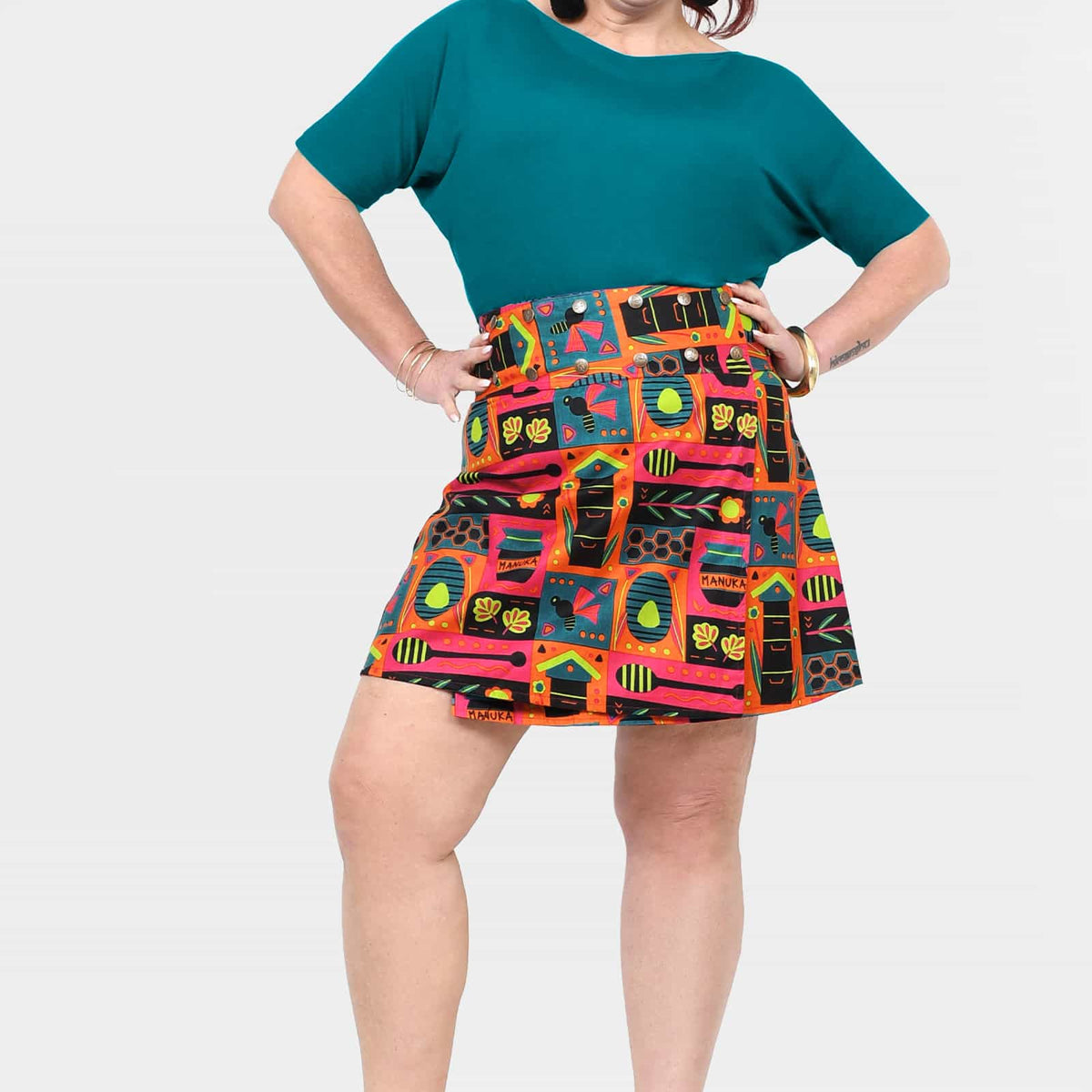 Flared short skirt with teal panel and bold multi-color graphic print
