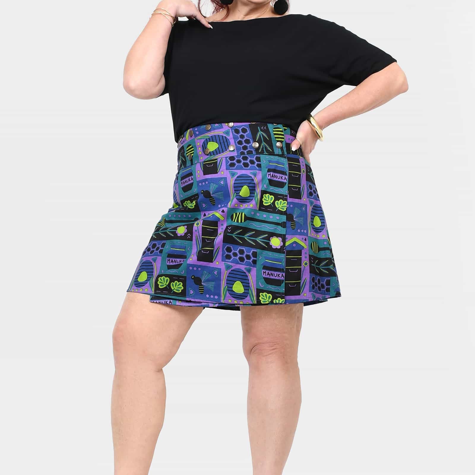 A-line reversible button short skirt with teal base and blue purple graphic print, pleats.