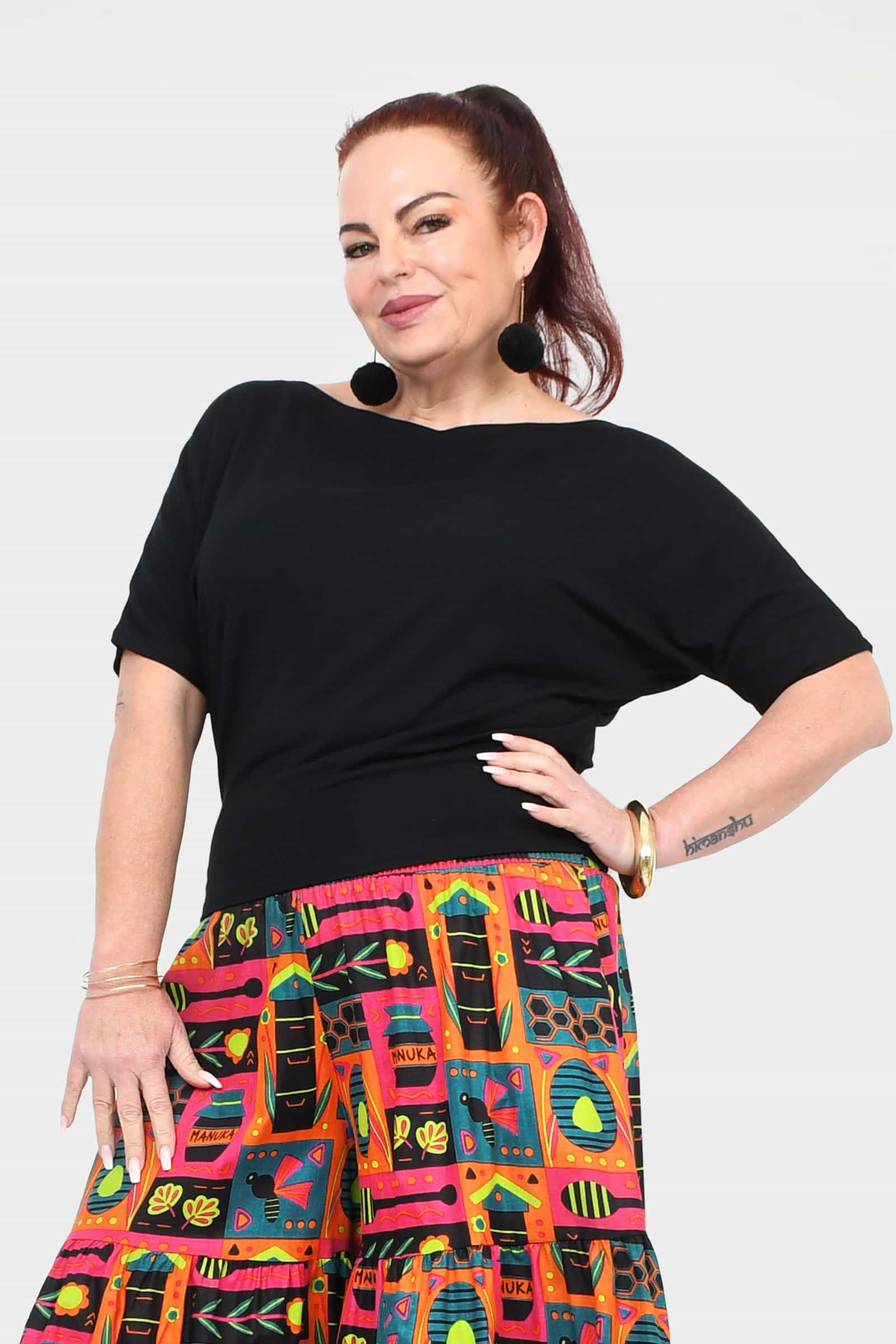 Black short-sleeve top with smooth relaxed fit and wide neckline at shoulder line