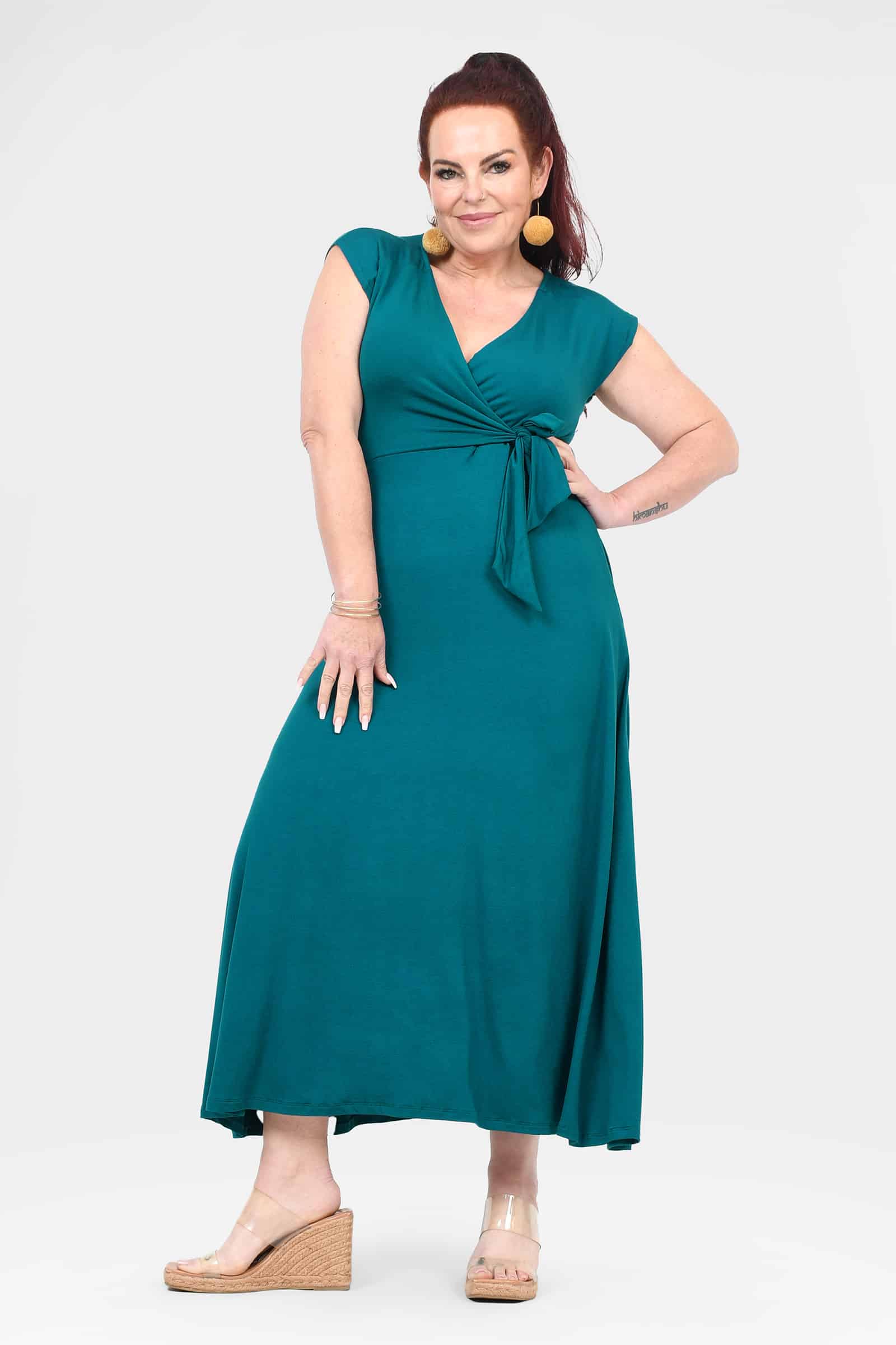 Dark teal sleeveless V-neck midi dress with front tie belt and flowing A-line skirt