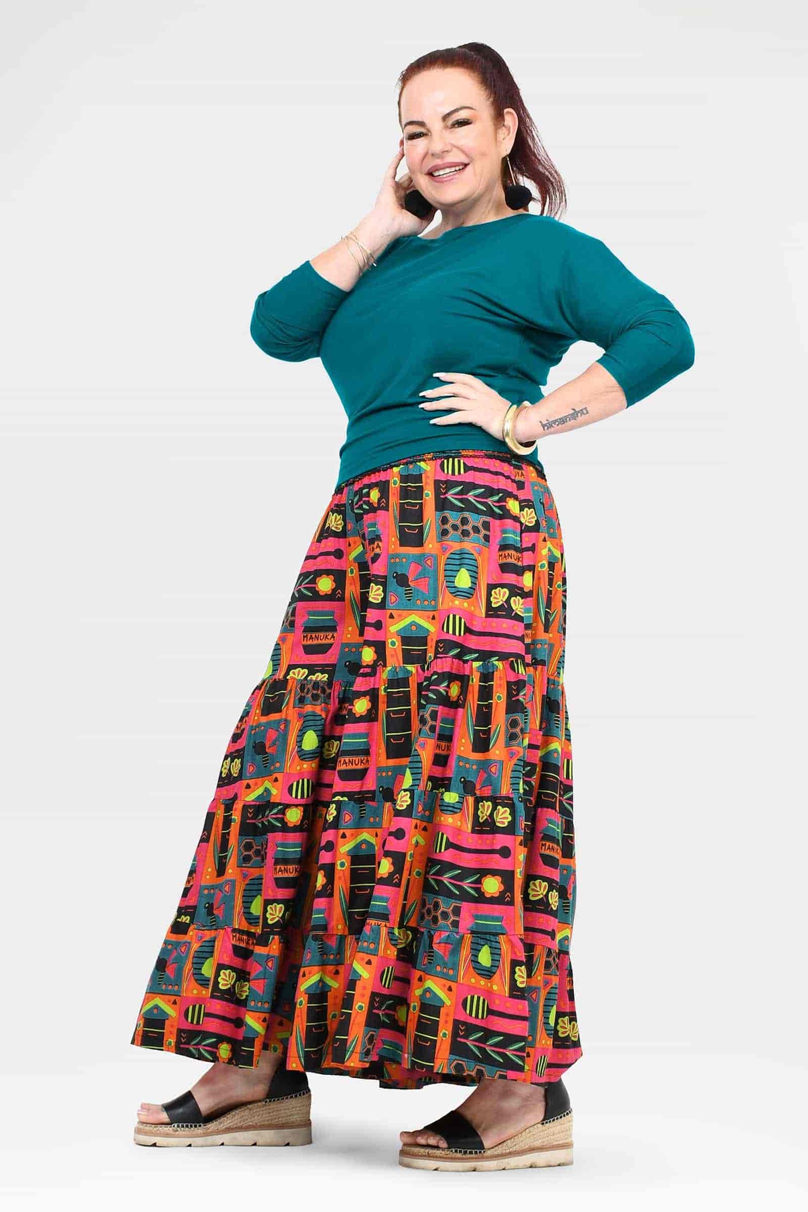 High-waist wide-leg pants with teal waistband and colorful graphic panel print