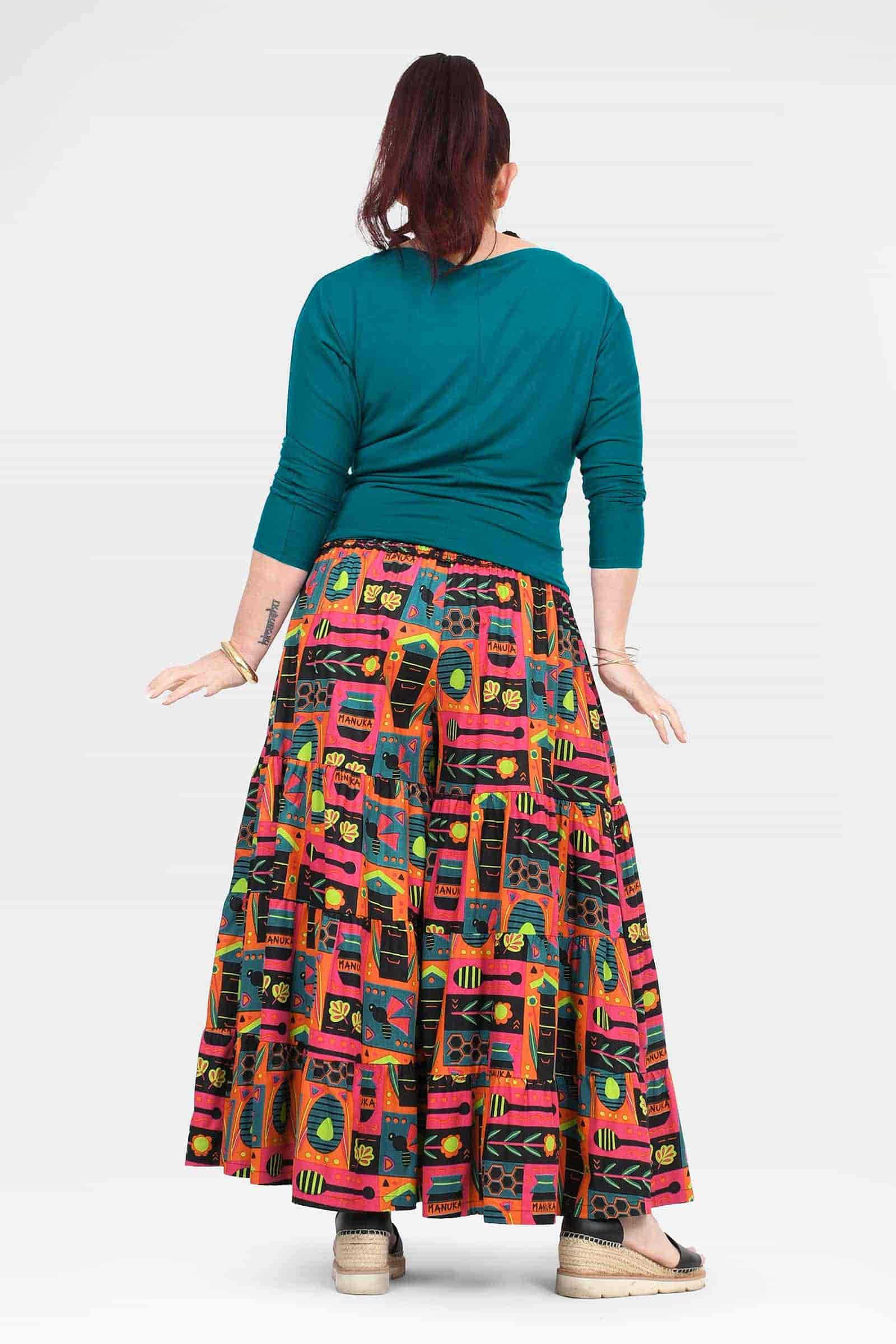Back view high-waist wide-leg pants with teal waistband and colorful graphic print