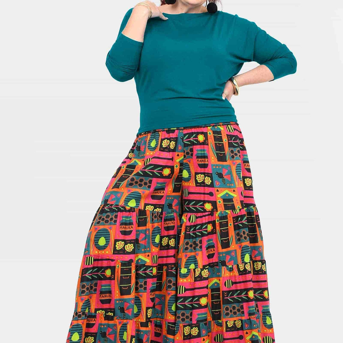 High-waist wide-leg pants with teal waistband and vibrant colorful graphic print