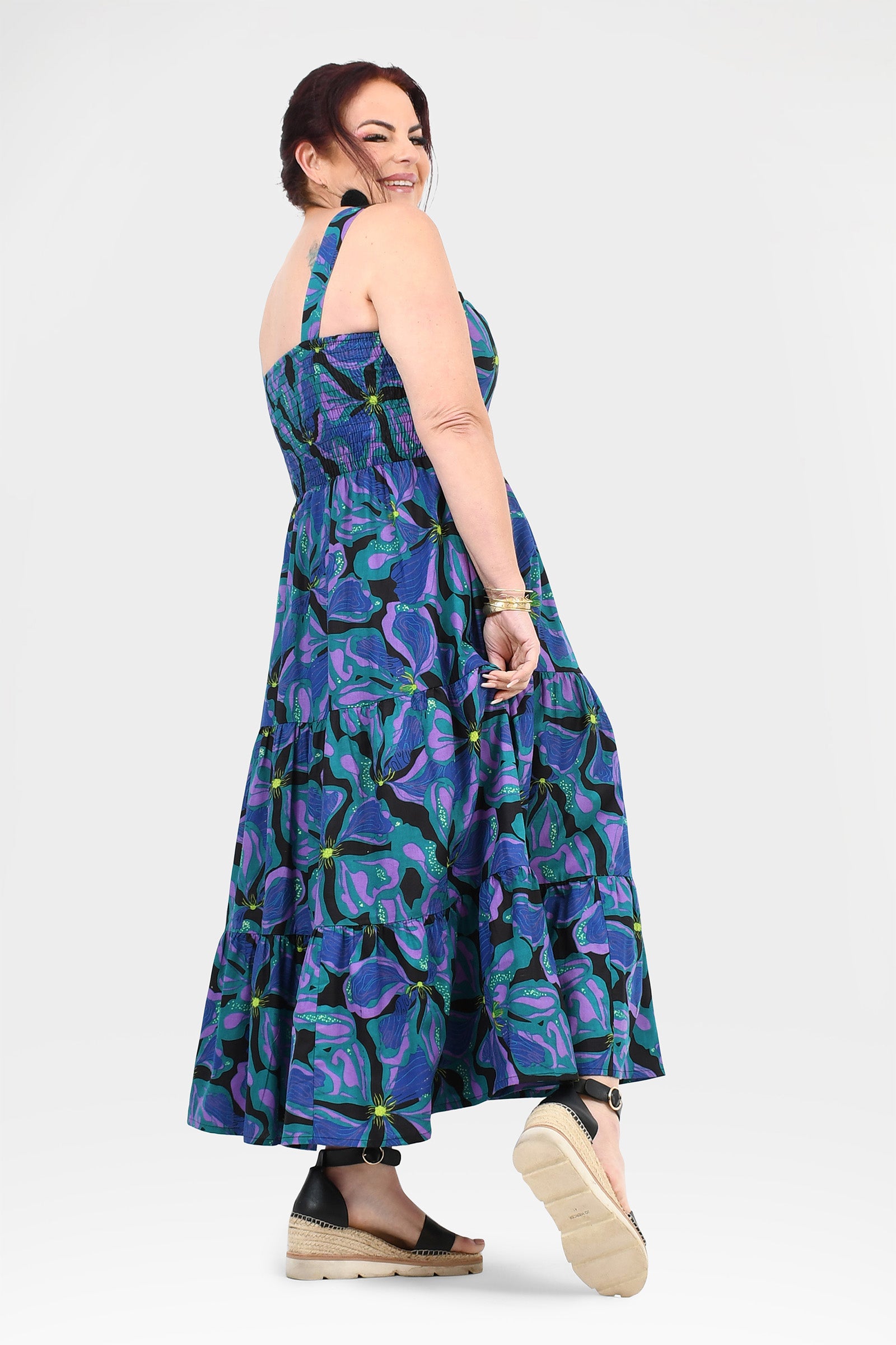 Sleeveless maxi dress in teal and purple with tiered ruffle skirt, abstract print