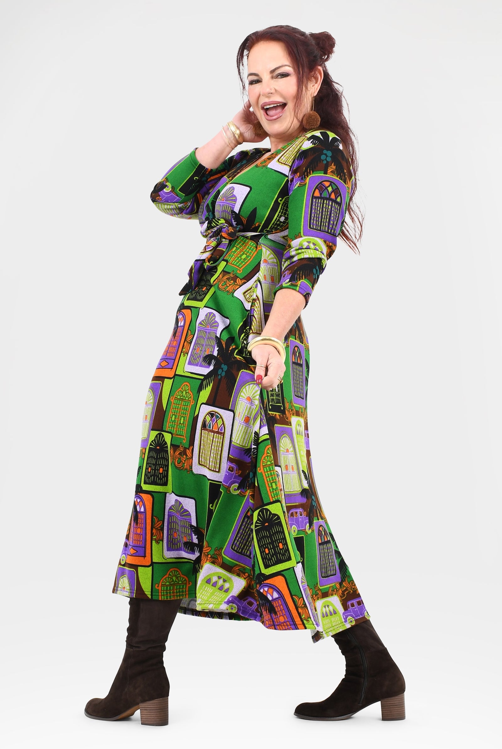 Woman wearing a colorful patterned dress on a white background