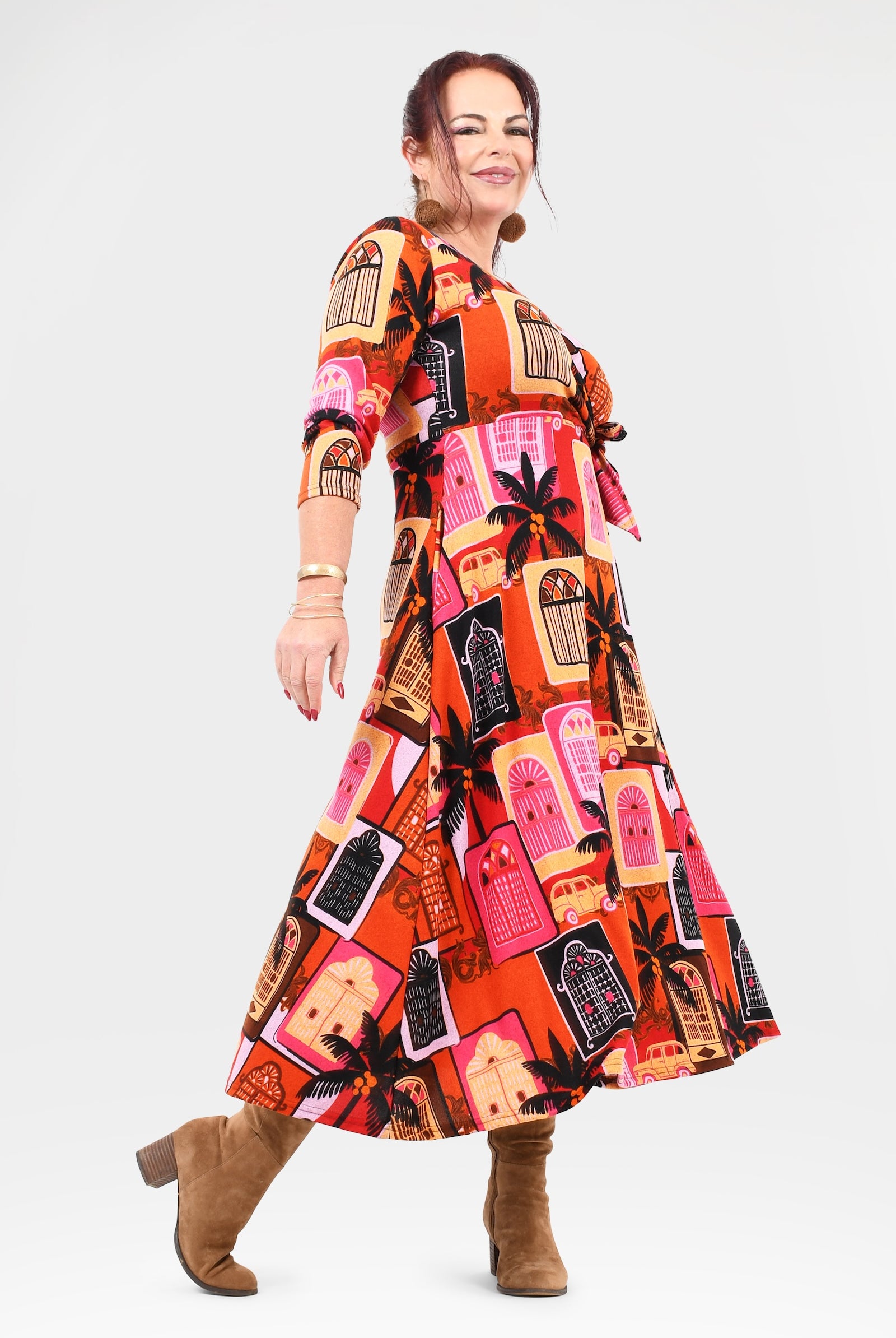 Woman wearing a colorful patterned dress on a white background