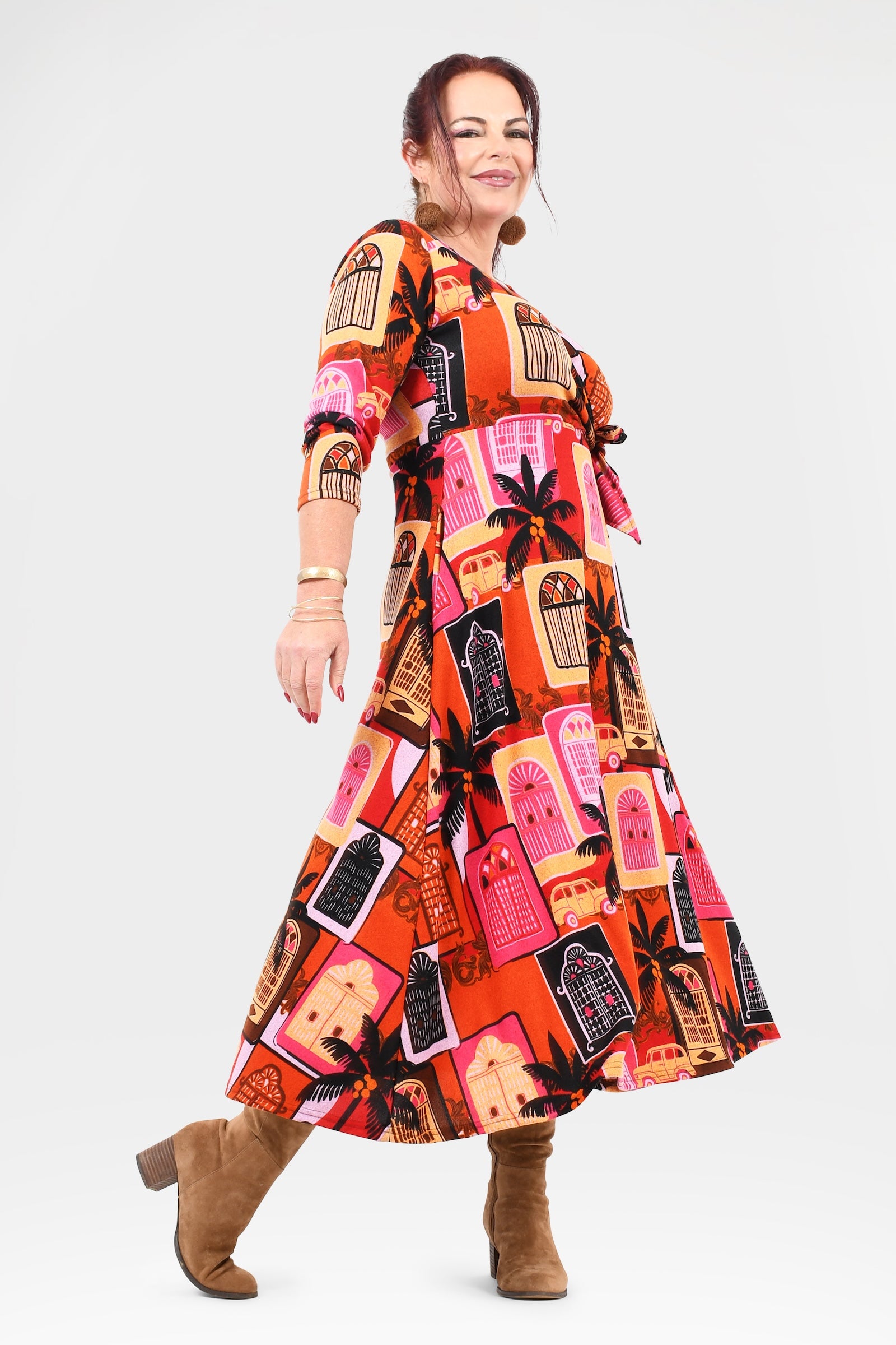 Woman wearing a colorful patterned dress on a white background