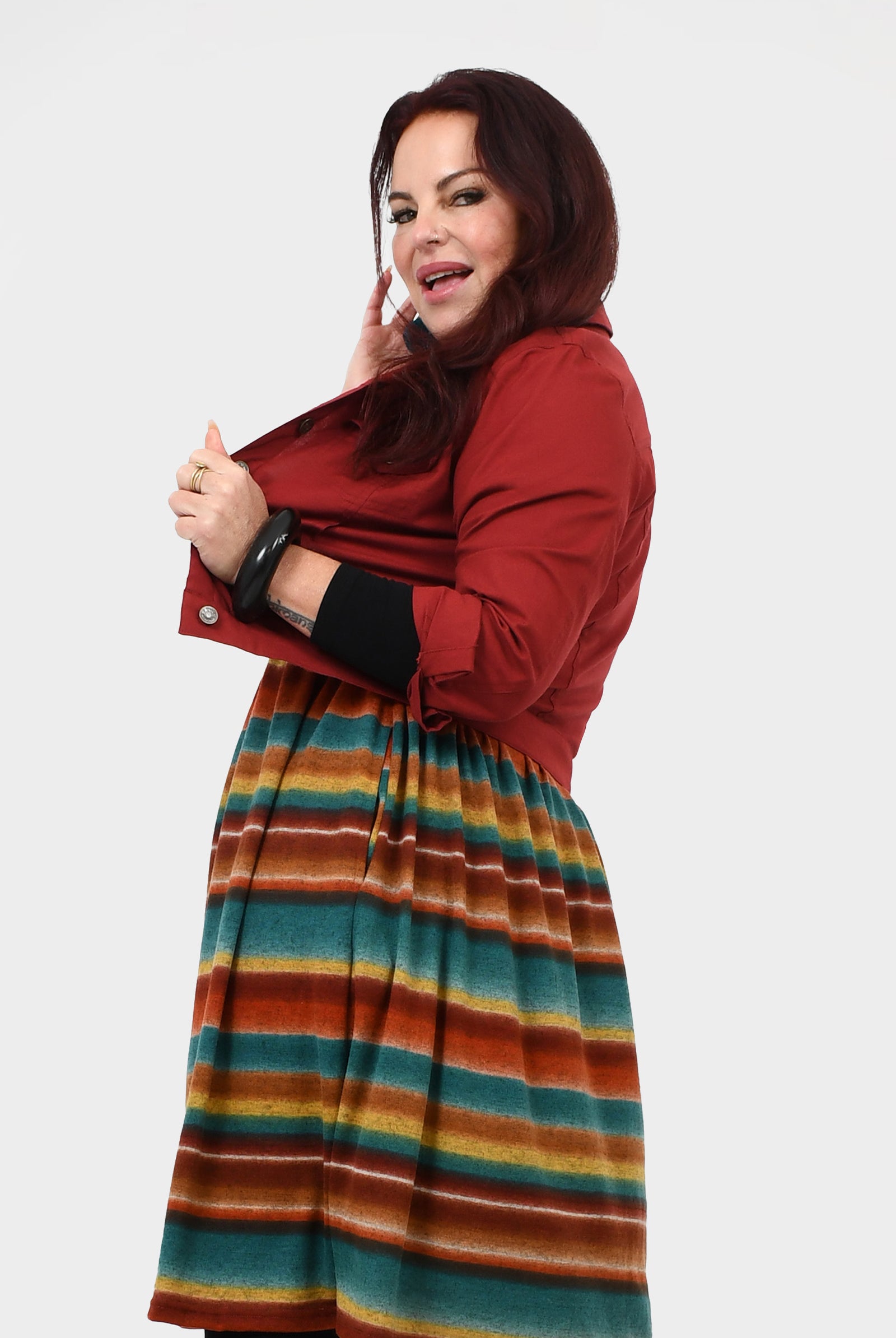 Dark red jacket in side profile with button cuffs and chest flap pockets
