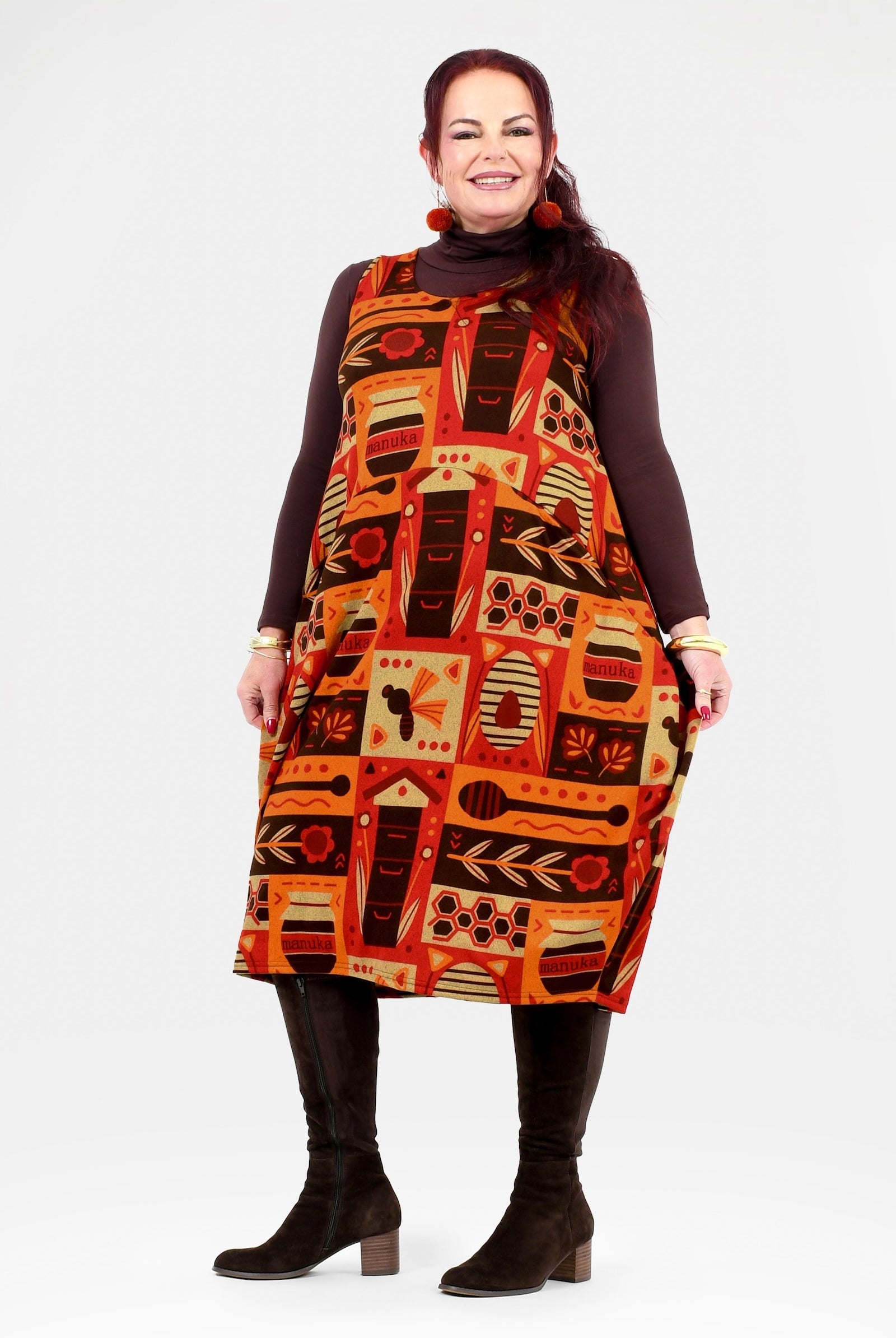 Woman wearing a patterned dress with a white background