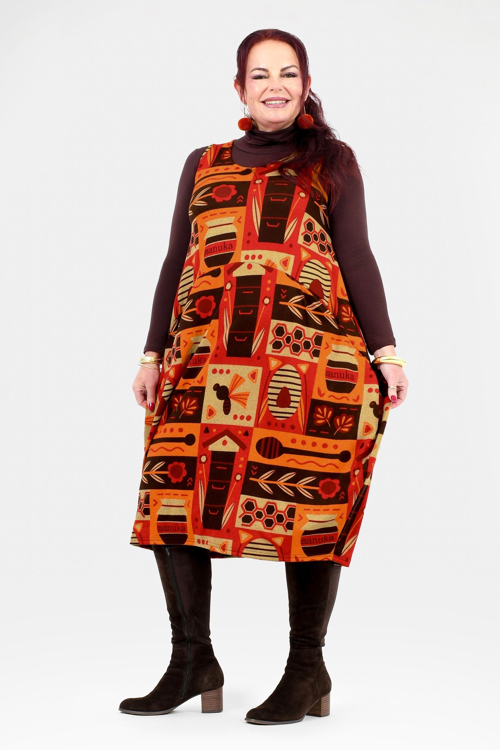 Woman wearing a patterned dress with a white background