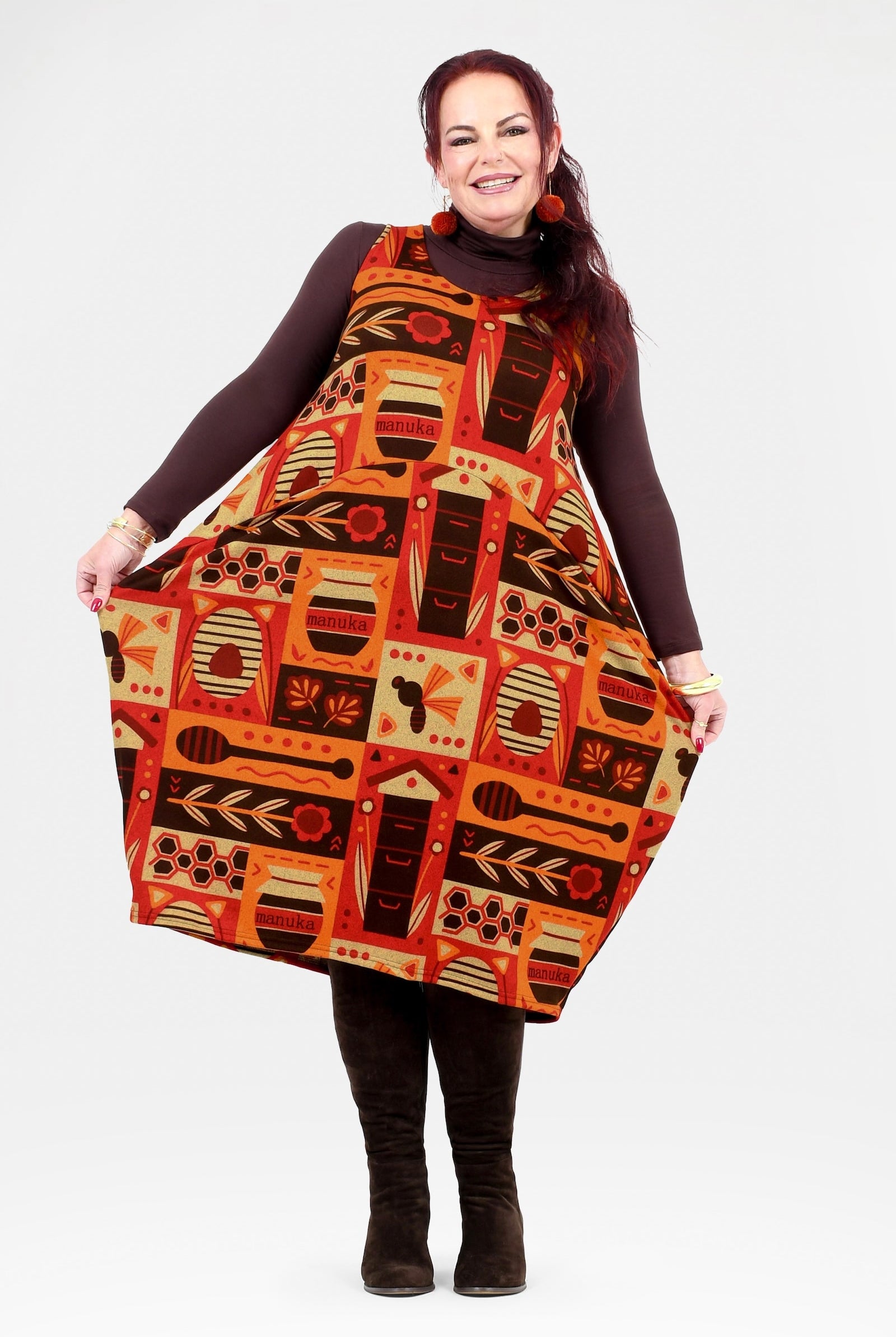 Woman wearing a patterned dress with a plain background