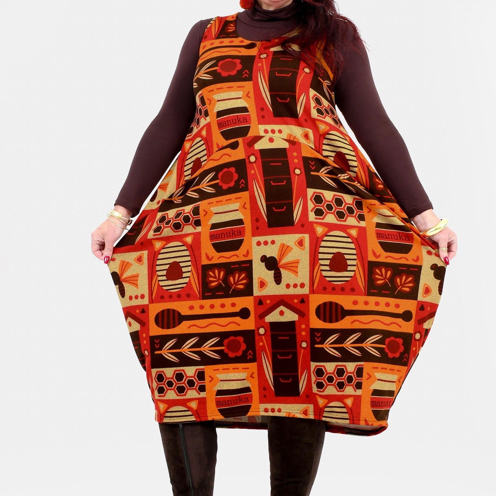 Woman wearing a patterned dress with a plain background