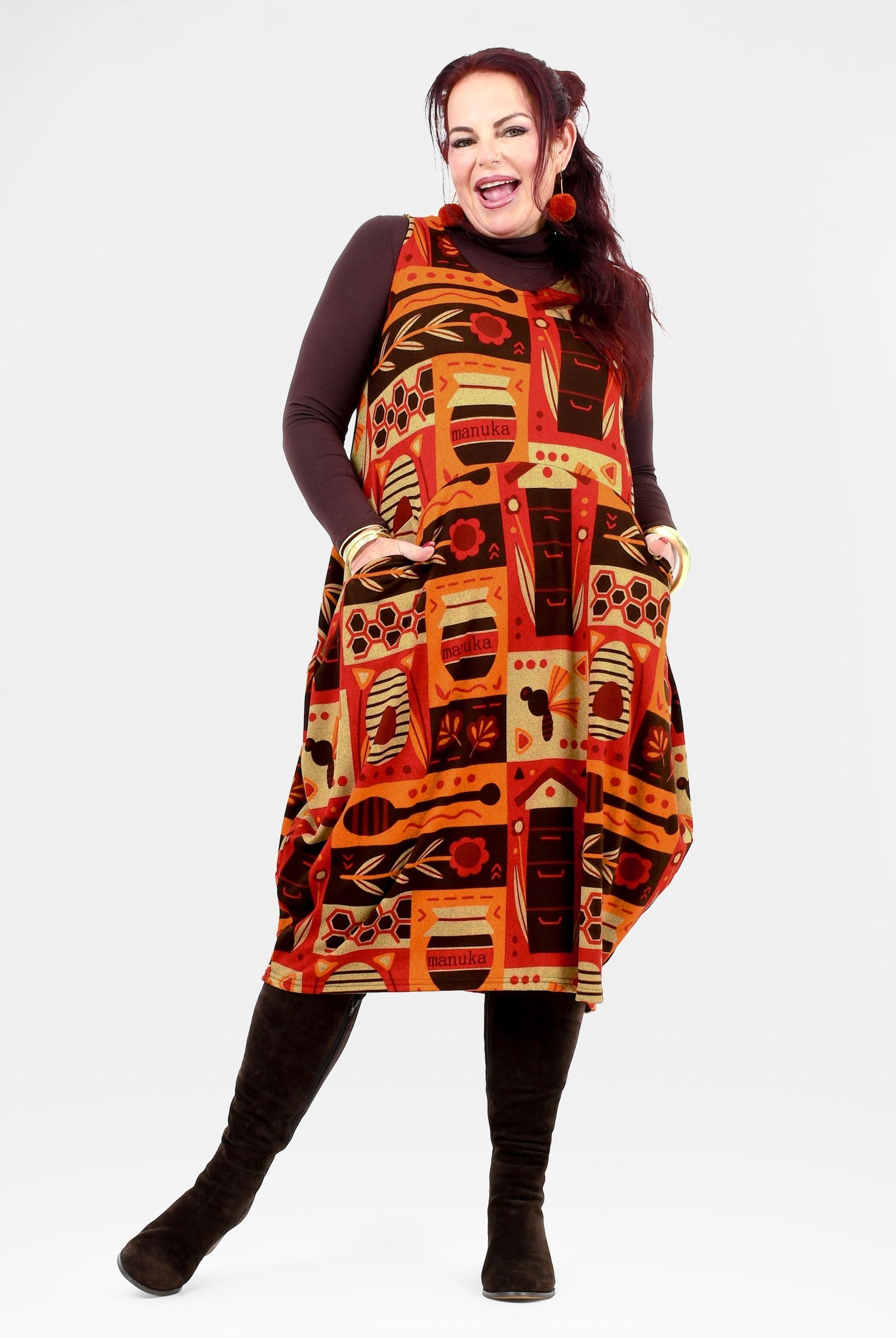 Woman wearing a patterned dress with a white background