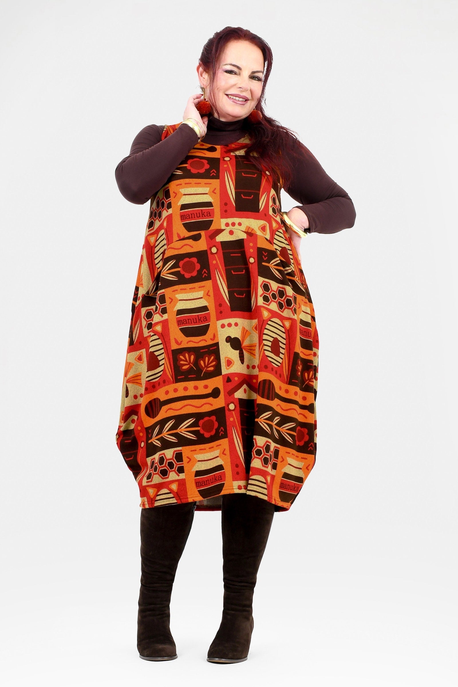 Woman wearing a patterned dress with a white background