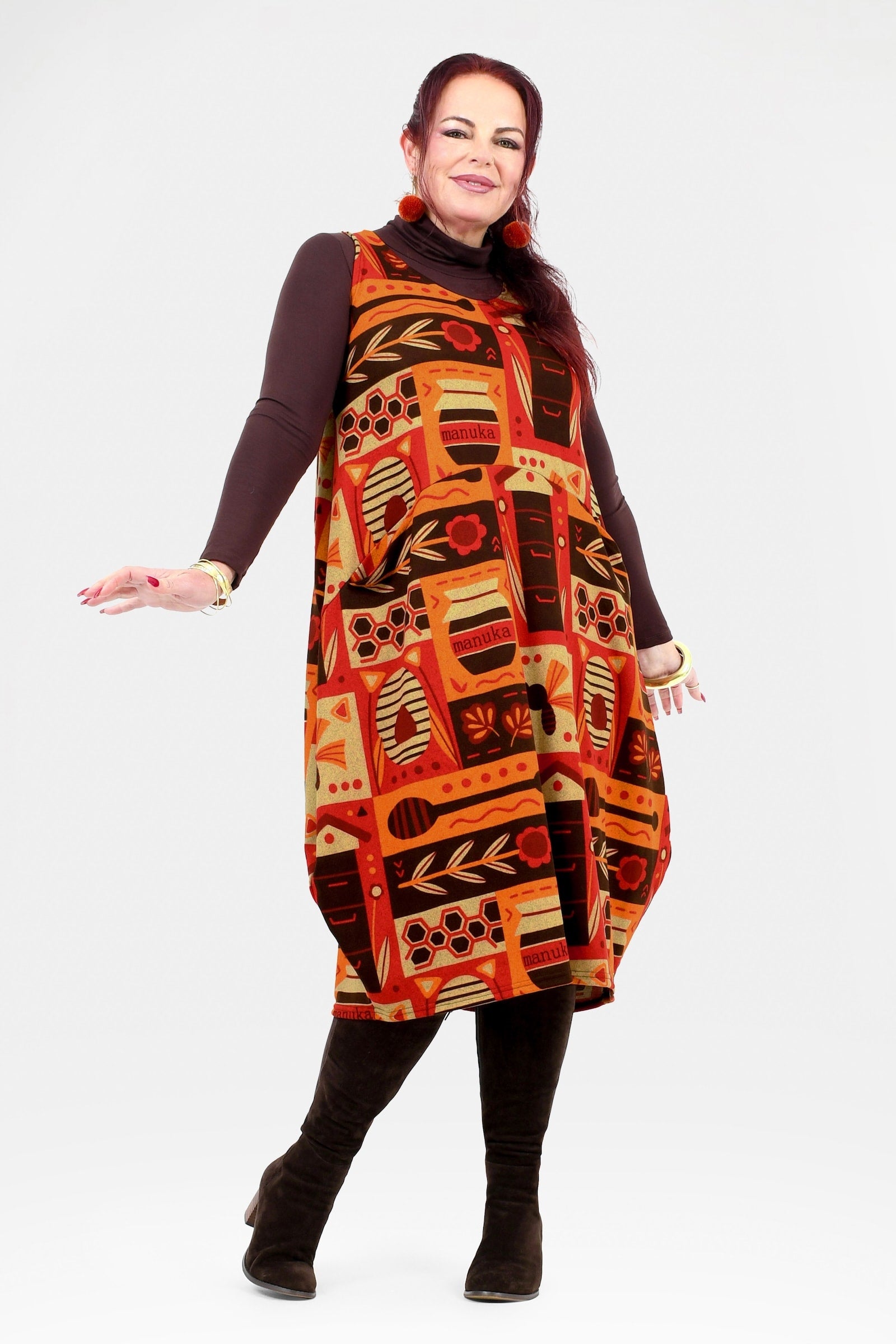 Woman wearing a patterned dress with a plain background