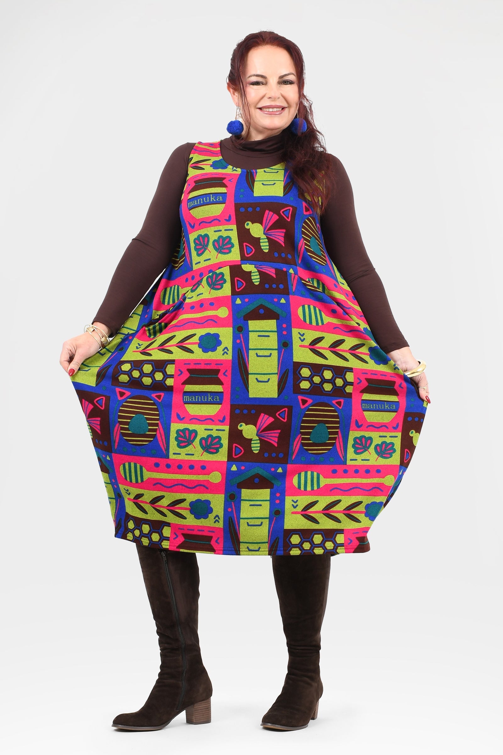 Woman wearing a colorful patterned dress on a white background