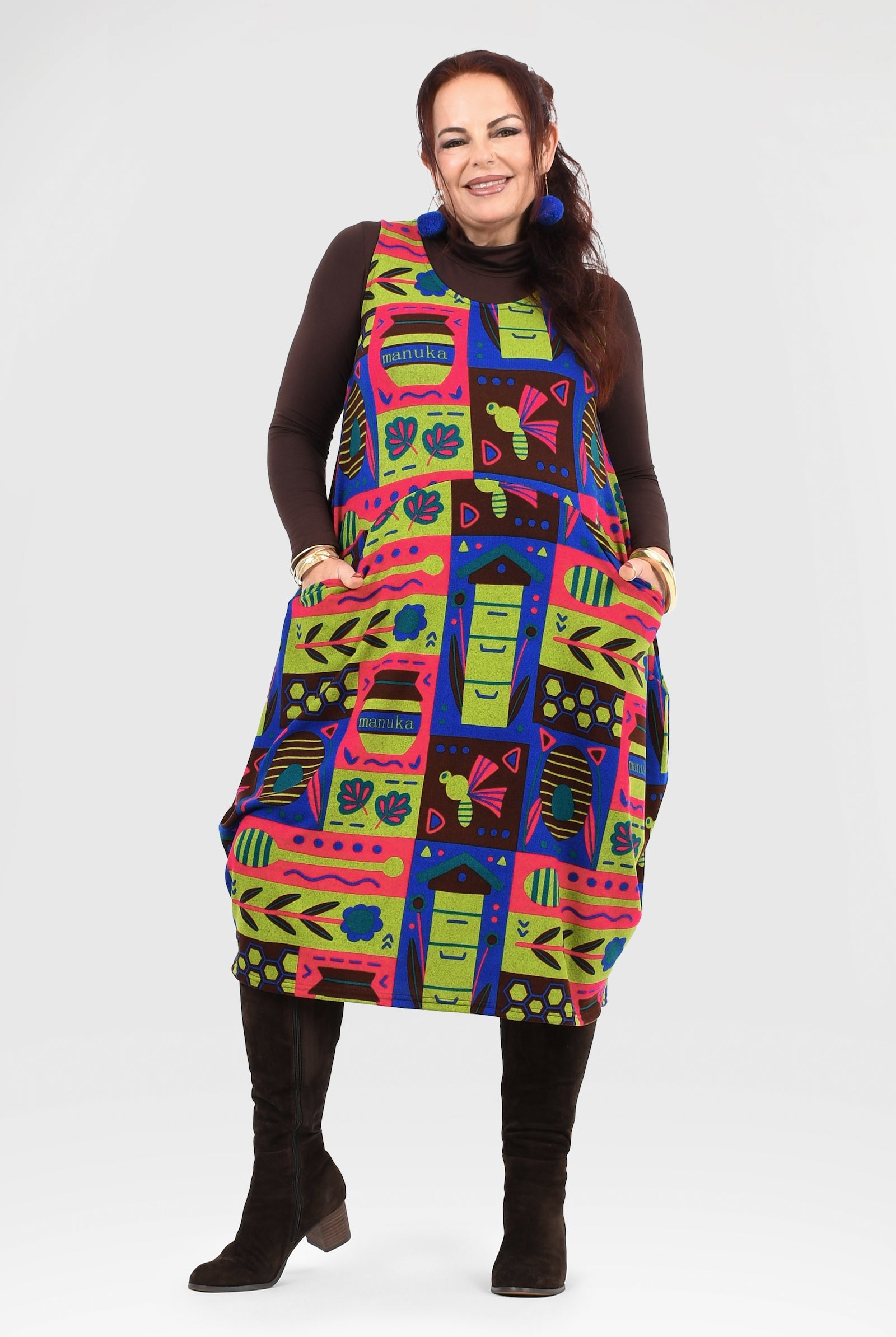 Woman wearing a colorful patterned dress on a white background